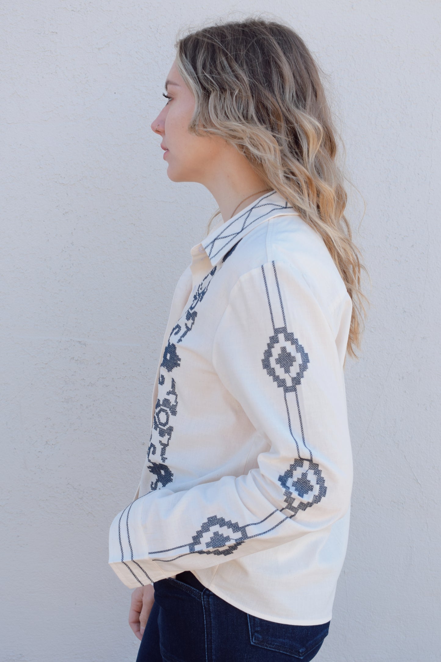 ivory button down full length with denim blue embroidery details along front, down sleeves, collar and cuffs. button cuffs, straight relaxed fit