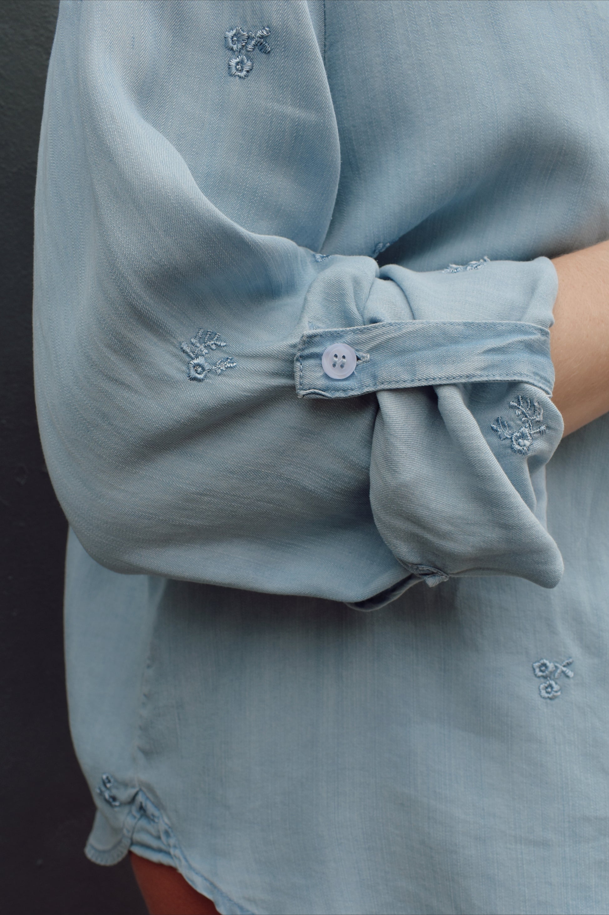 tencel denim chambray button down shirt, oversized relaxed fit, delicate floral embroidery accents same color as button down, one breast patch pocket, sleeves have button for roll up option