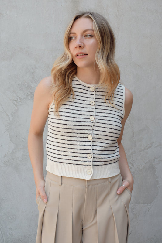 cropped striped sweater vest natural wood colored buttons down the front, crew neck, pin horizontal black stripes, solid ribbed hem