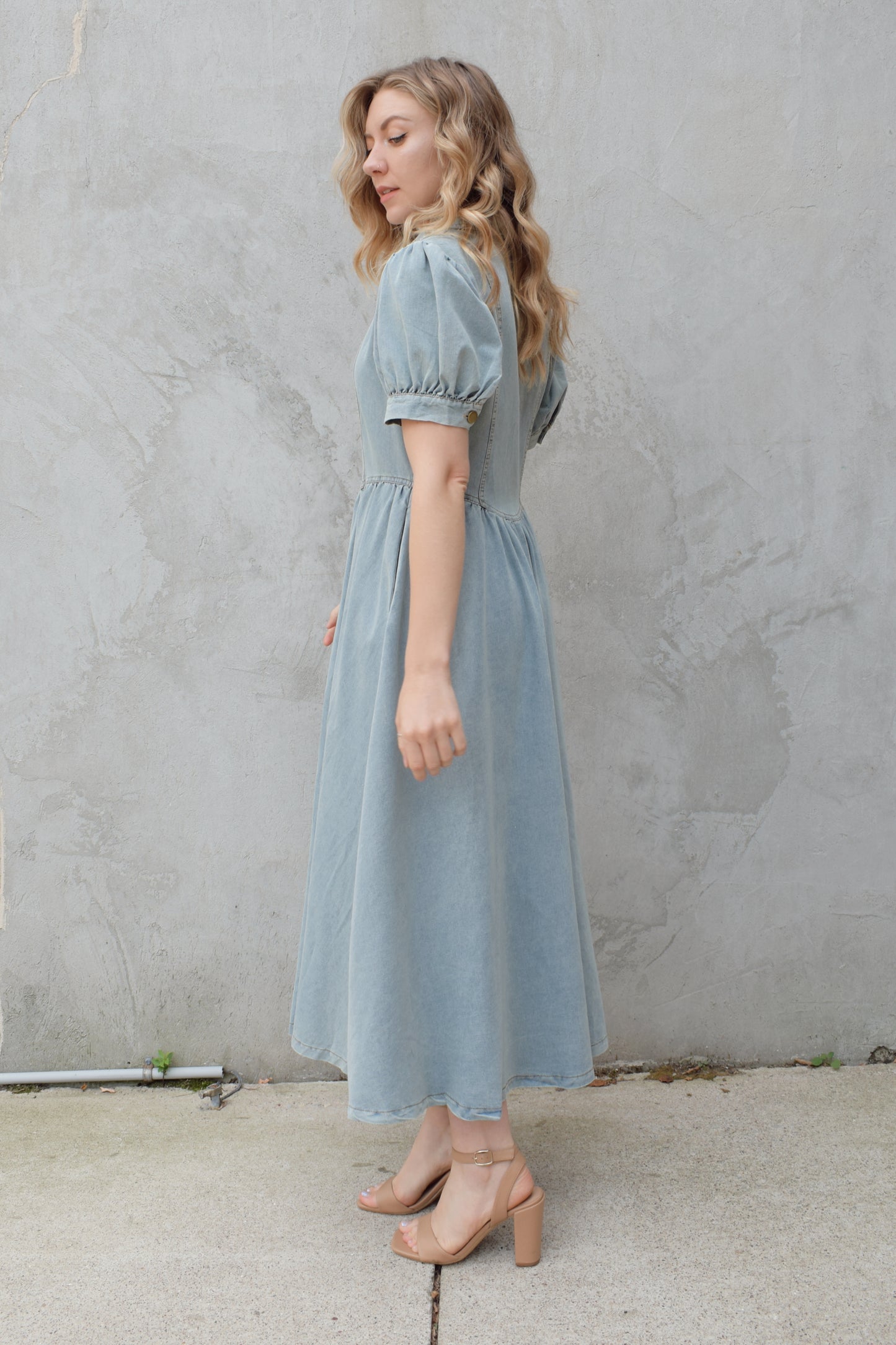 denim midi dress light wash with puff short sleeves with button cuffs button down front, v neck and collar, gathered at waist with a line skirt, has pockets