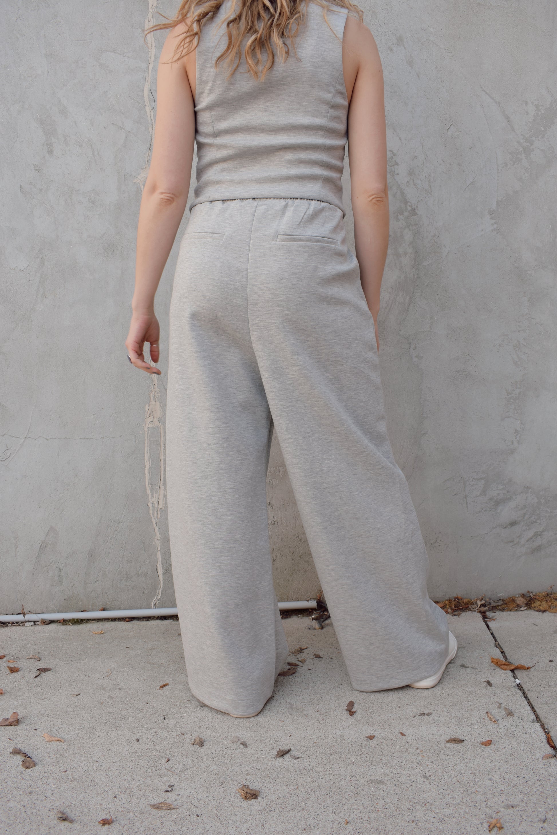sweatpants style peated trousers with elastic waistband, pockets, fake back pockets, wide leg full length