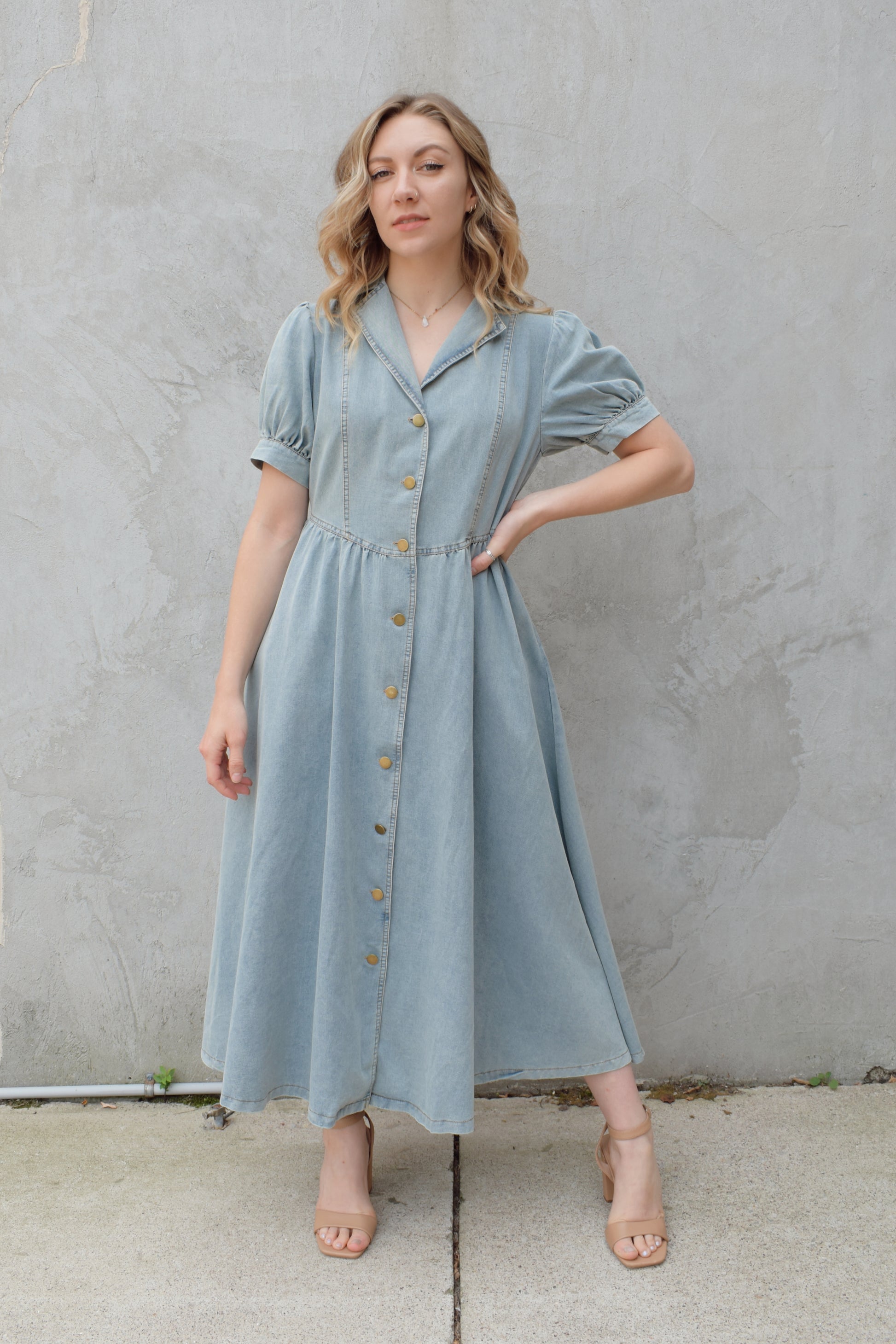 denim midi dress light wash with puff short sleeves with button cuffs button down front, v neck and collar, gathered at waist with a line skirt, has pockets