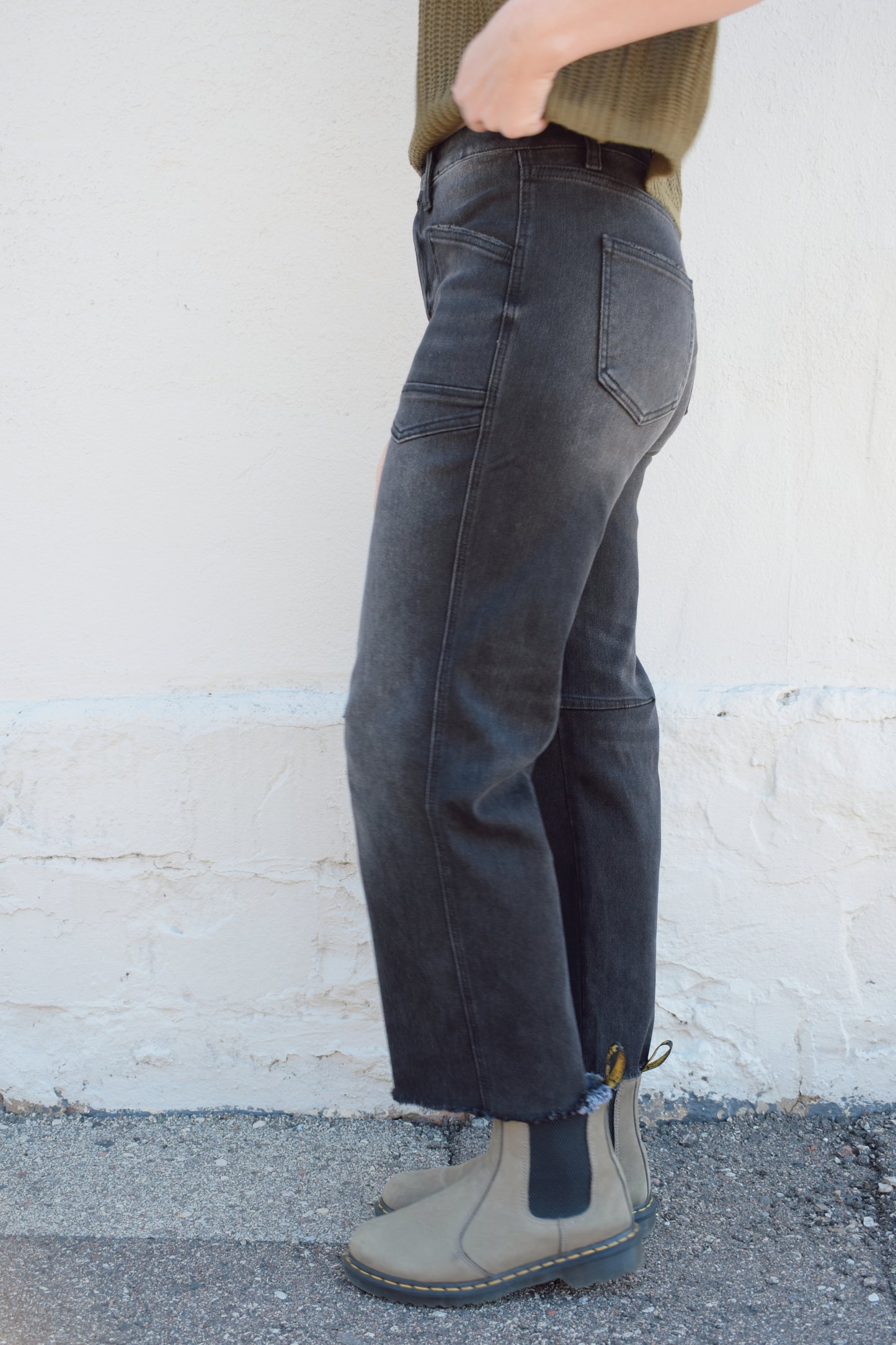 black washed cropped slight barrel jeans stretch denim slanted patch pockets, raw hem, seam detail at knee, high rise, no holes