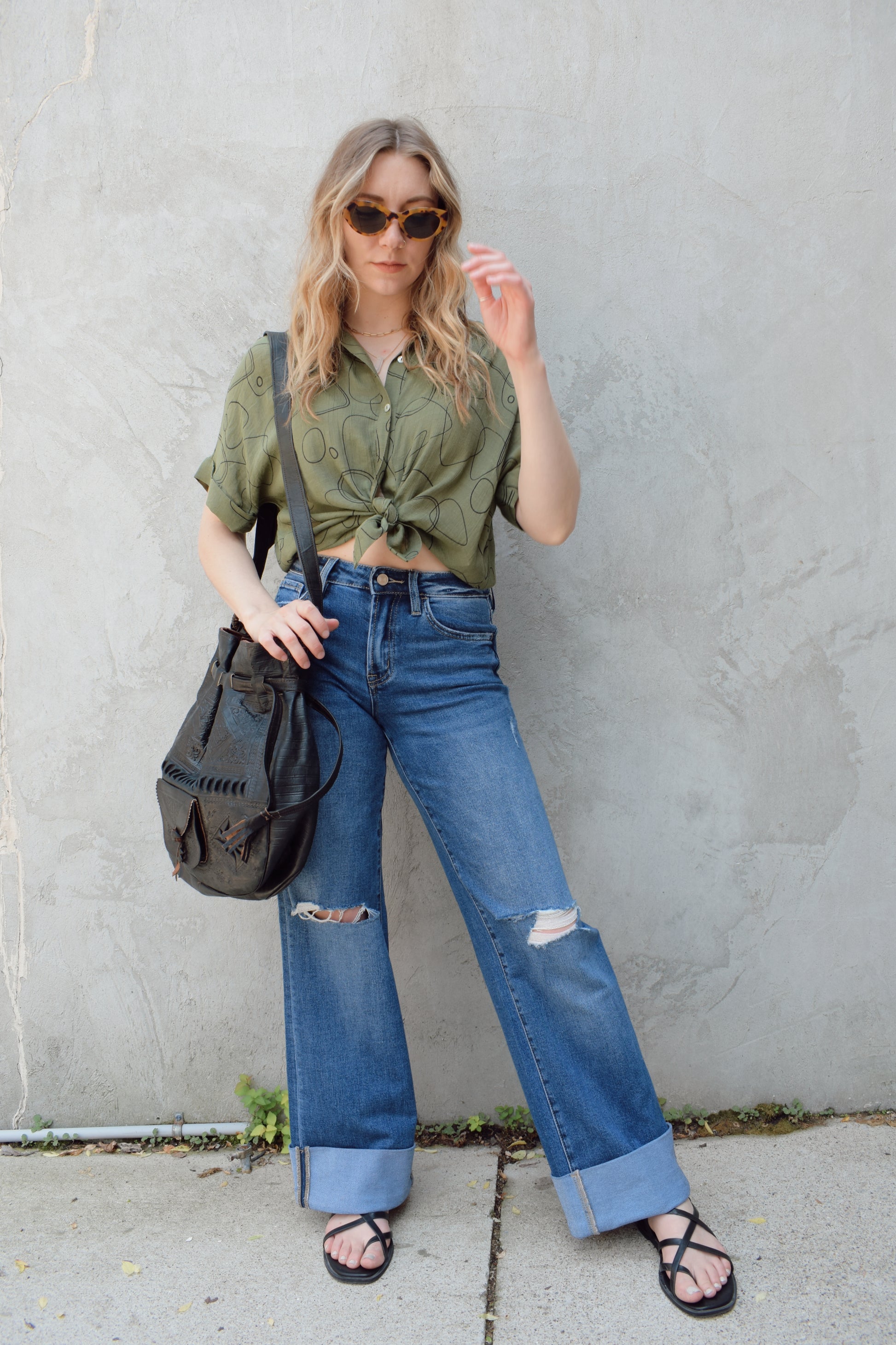 wide leg wide cuff at hem stretch denim jeans with holes in both knees, full length, dark wash, zip and button enclosure