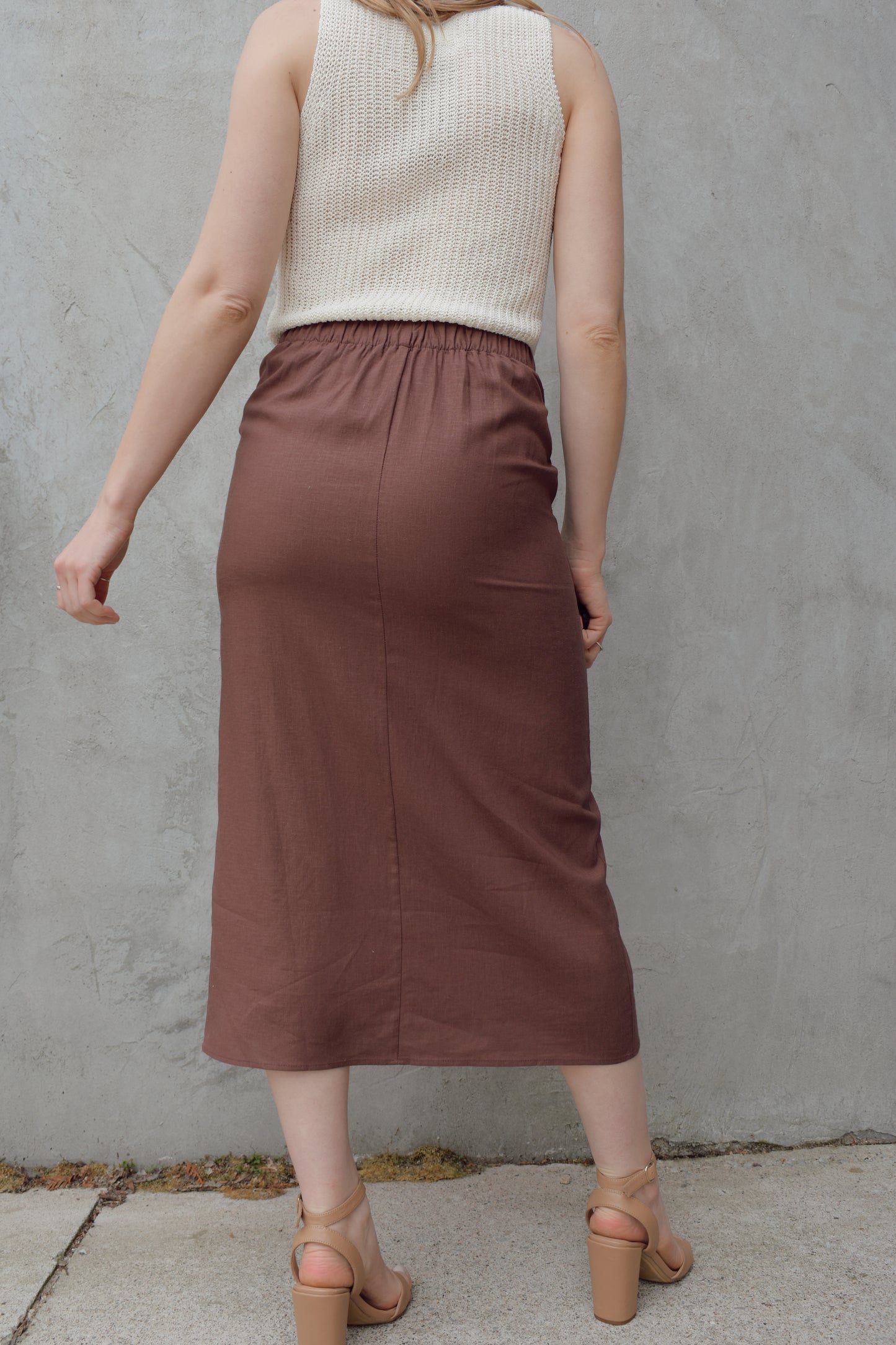 high waisted linen wrap skirt with 3 wooden button enclosure midi length stretch on back of waistband