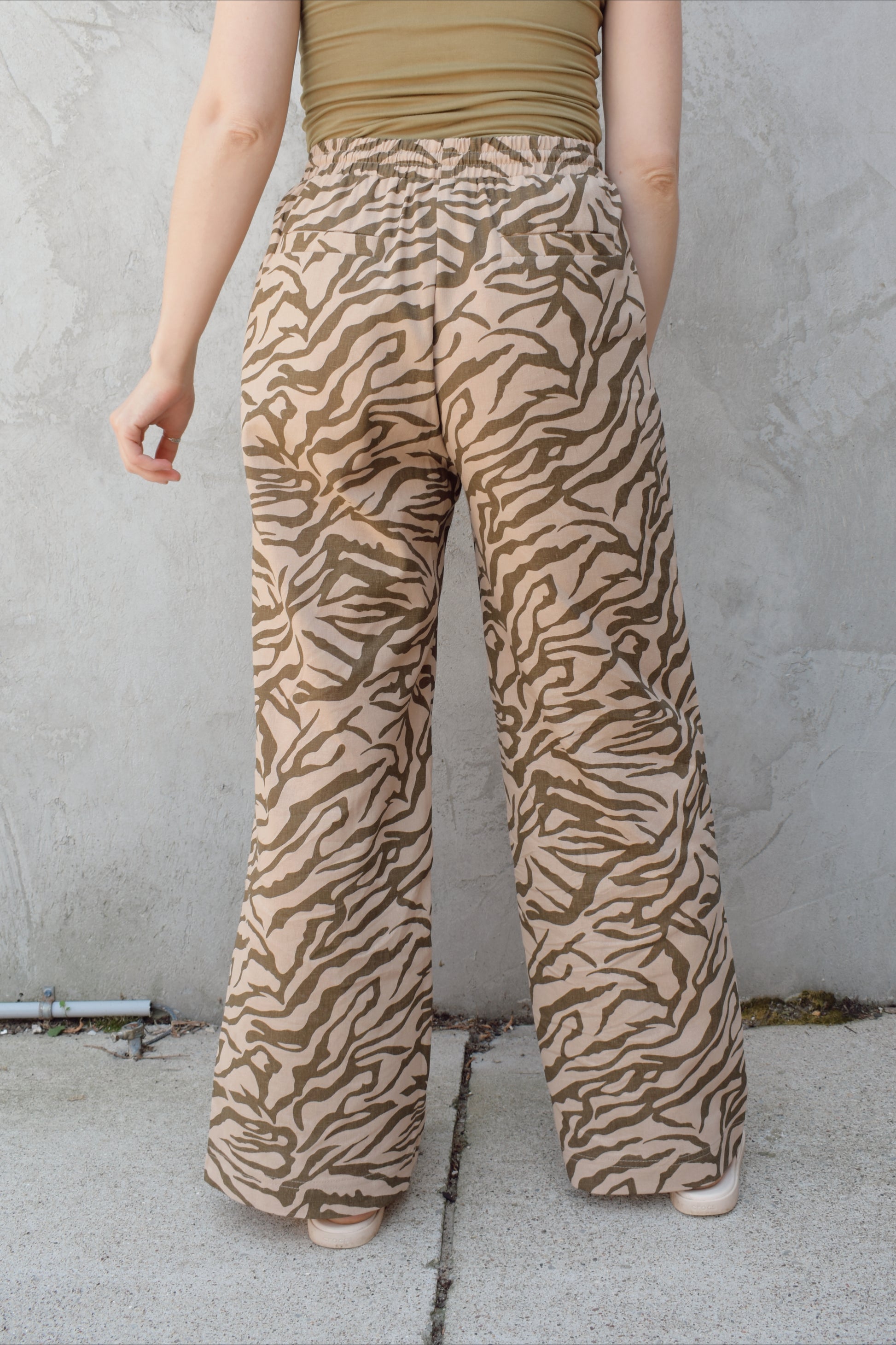 zebra print linen blend pants with relaxed wide leg fit, high rise with elastic waist and drawstring, front patch pockets and fake back pocket slits, full length