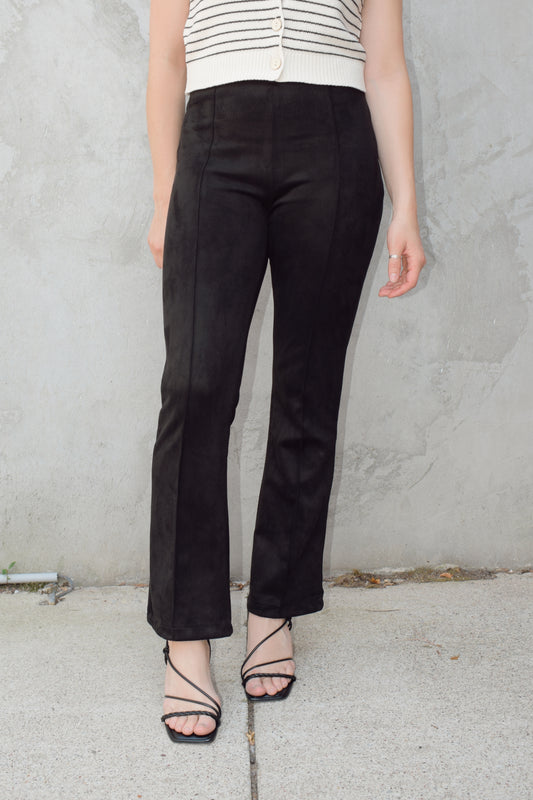 black faux suede pants with a slight cropped kick flare, raised seam detail along front of pant legs, zip side enclosure, high waisted