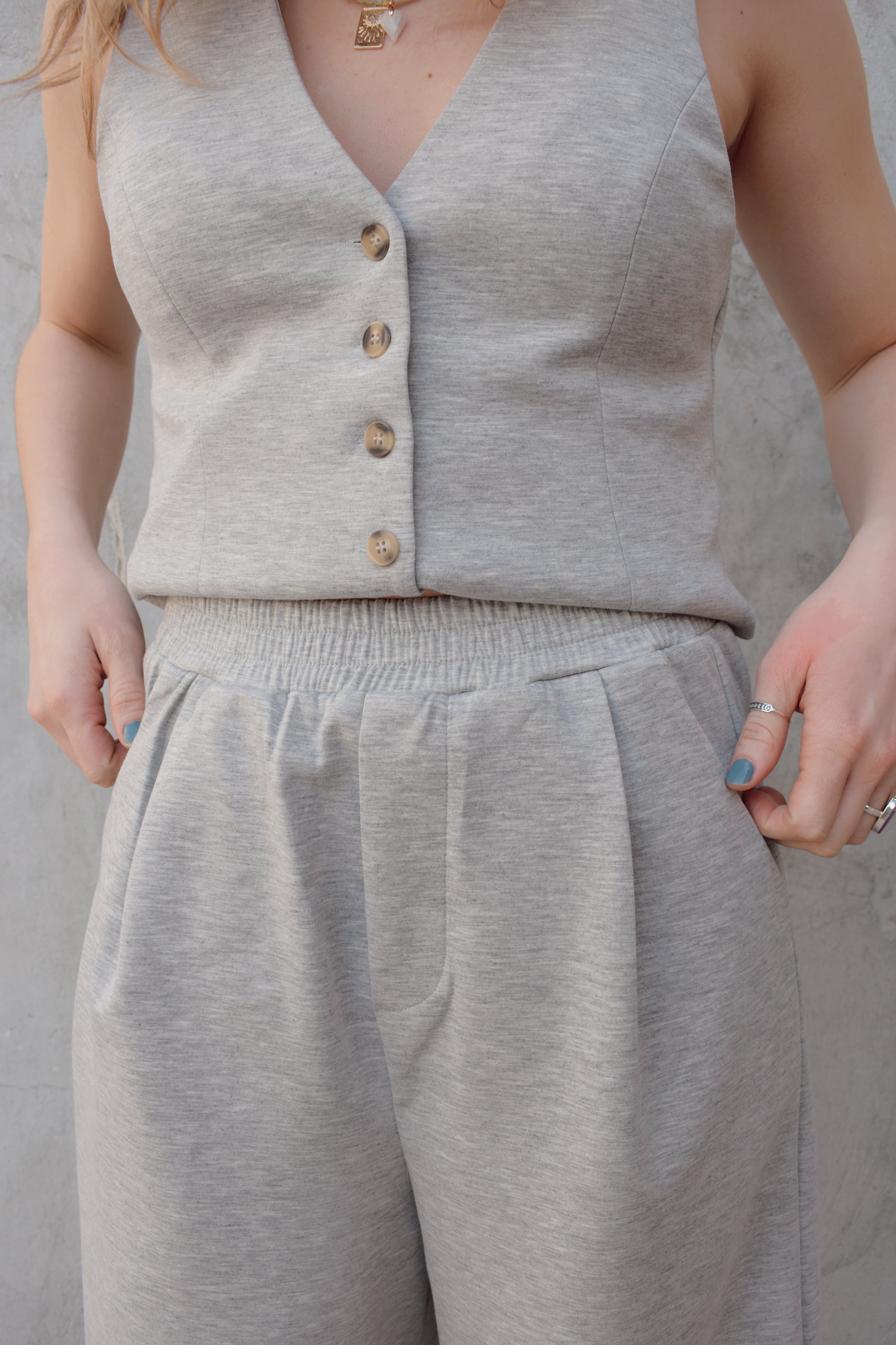 sweatpants style peated trousers with elastic waistband, pockets, fake back pockets, wide leg full length