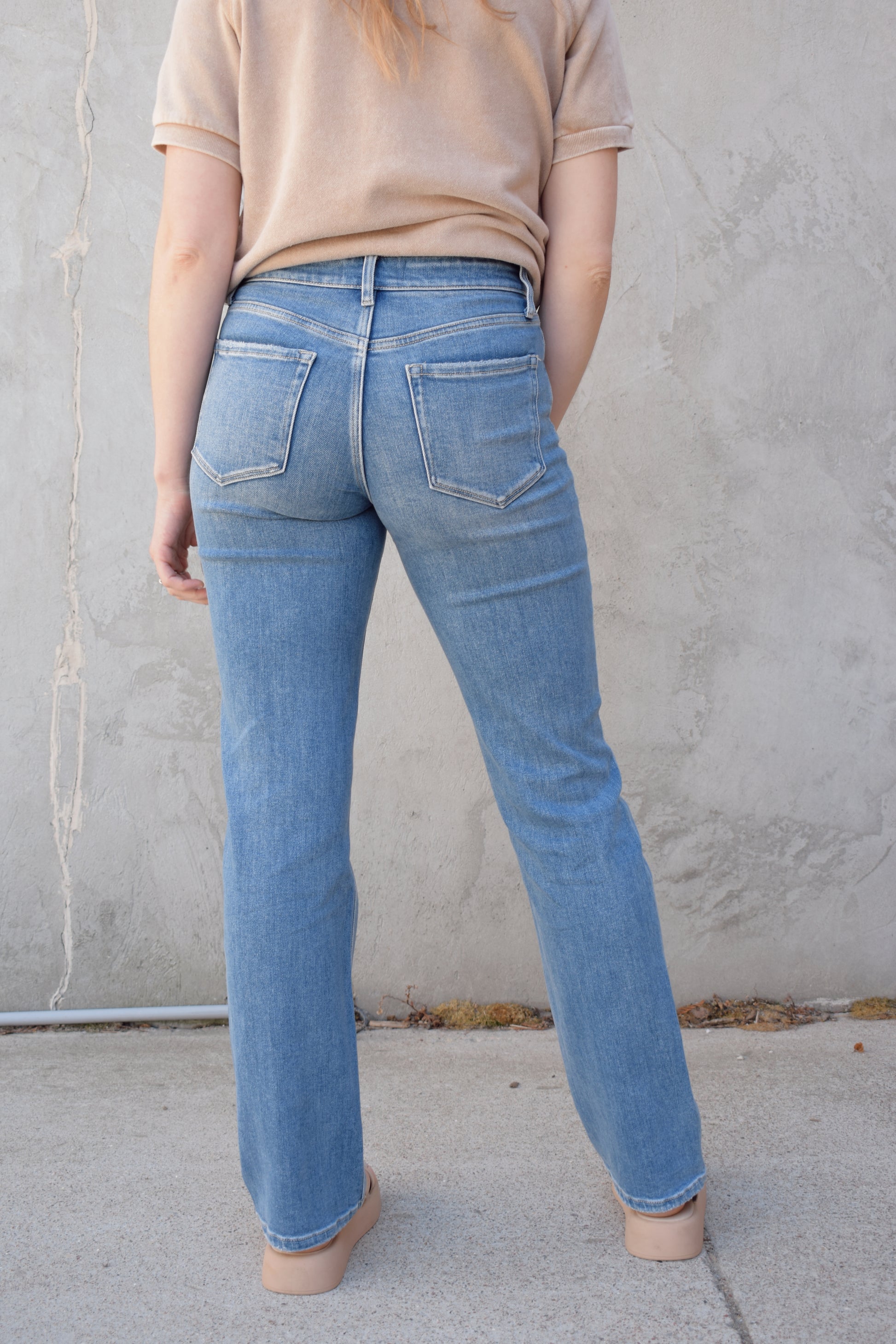 high rise straight jeans medium to light wash with distressing and holes at knees full length high waisted has beltloops stretch denim