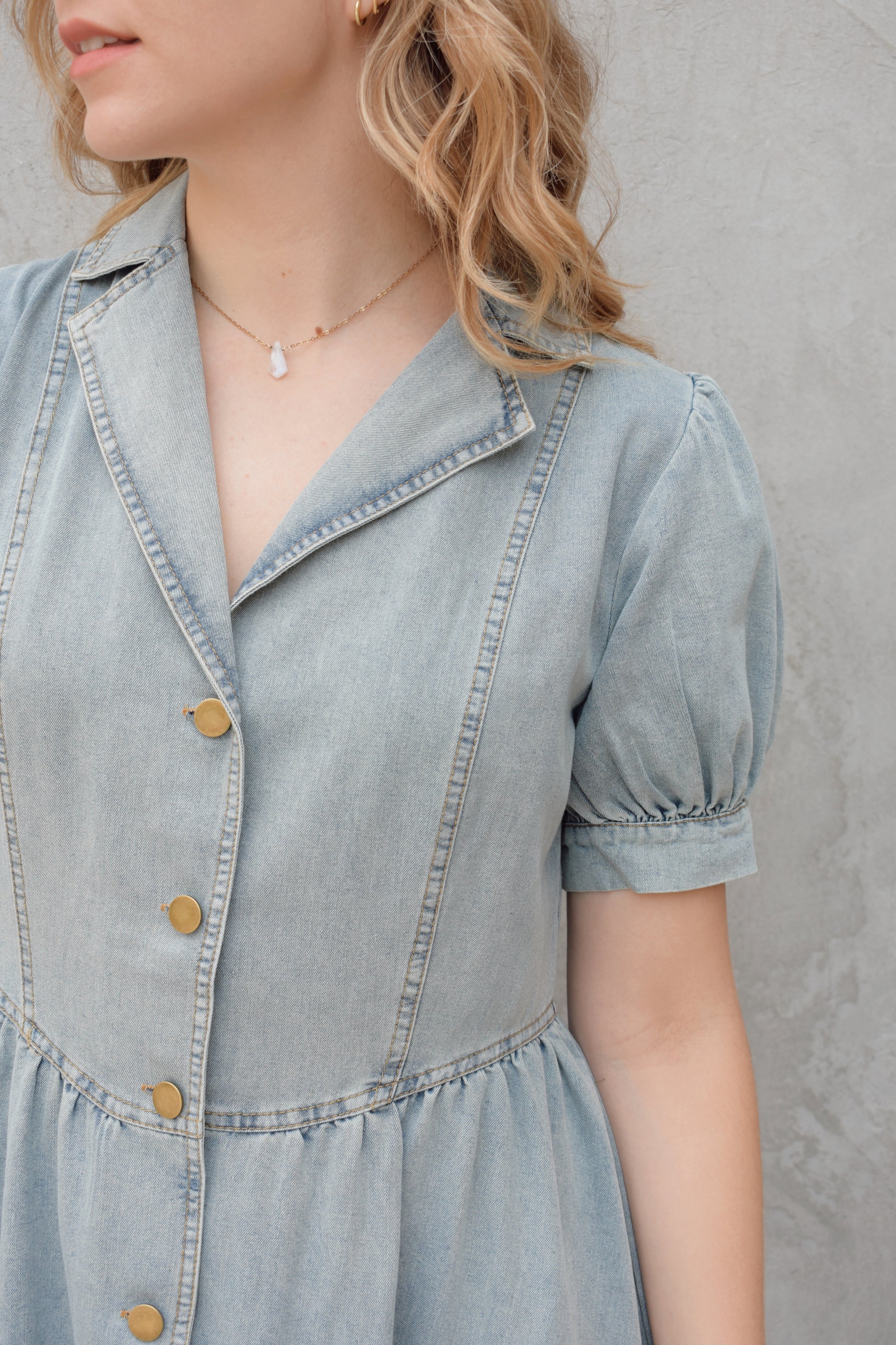denim midi dress light wash with puff short sleeves with button cuffs button down front, v neck and collar, gathered at waist with a line skirt, has pockets