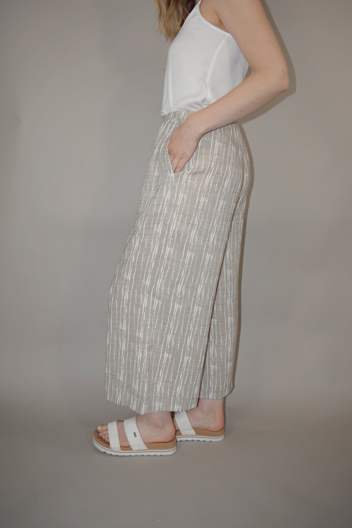 flowy cream and white printed pants slightly cropped, elastic waistband, has pockets, lightweight