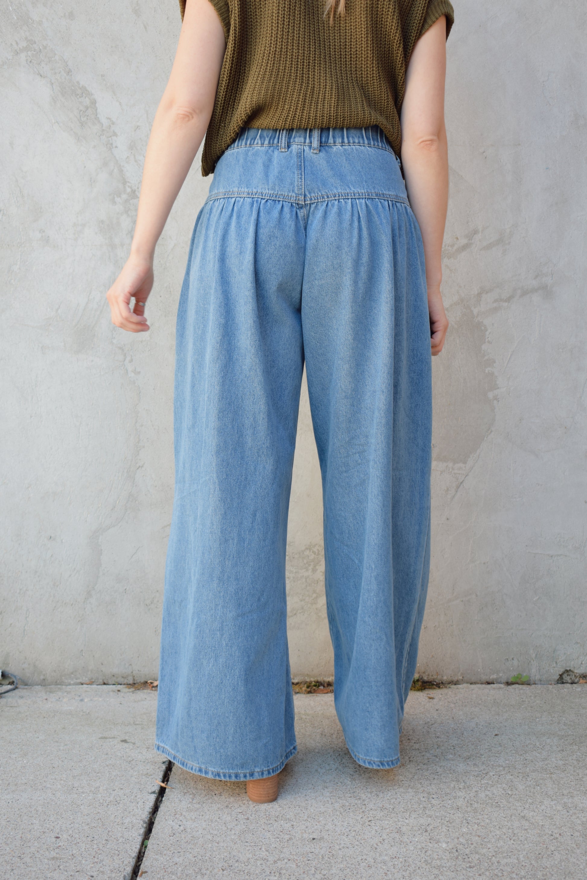 high waisted palazzo jeans light weight has pockets dropped yoke seam and pleats wooden button front enclosure
