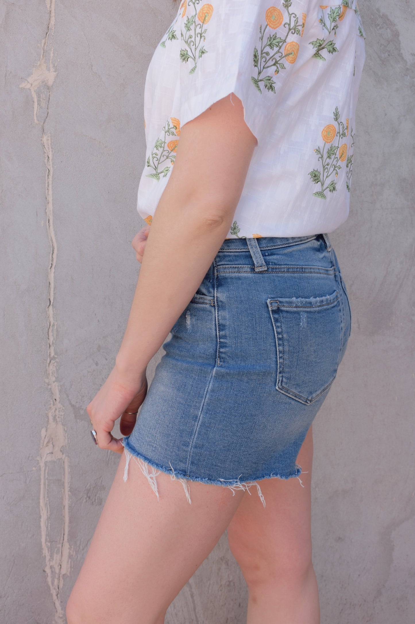 high rise stretch denim shorts with raw hem no holes front and back pockets zip and button enclosure has beltloops medium wash