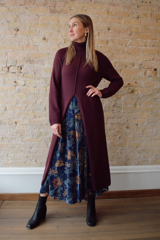 turtleneck tunic sweater dress with split in front up to above waistline, exposed seam detailing down the front and back