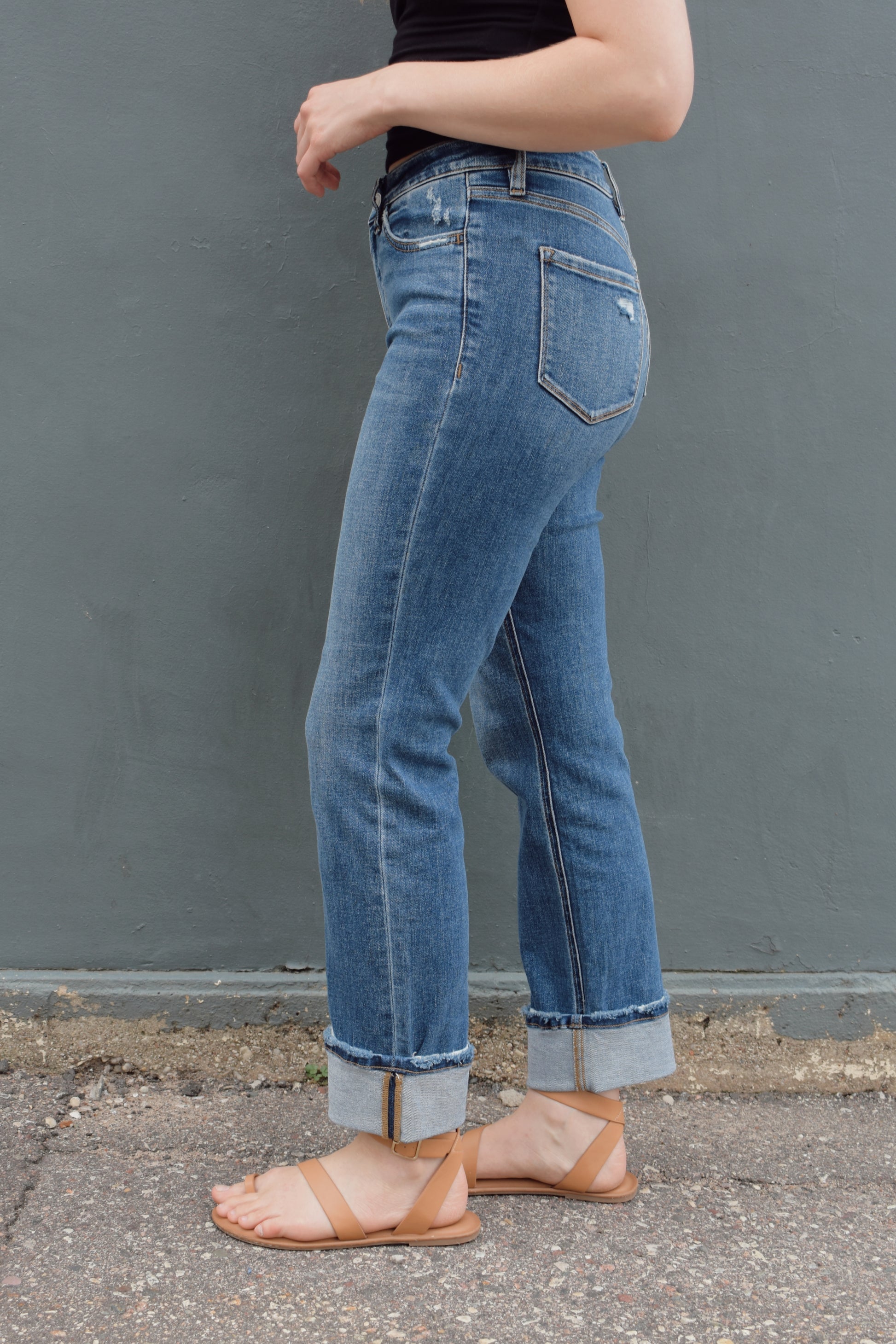 stretch denim straight jeans with cuff that isn't sewn in, zip and button enclosure, no holes, medium wash