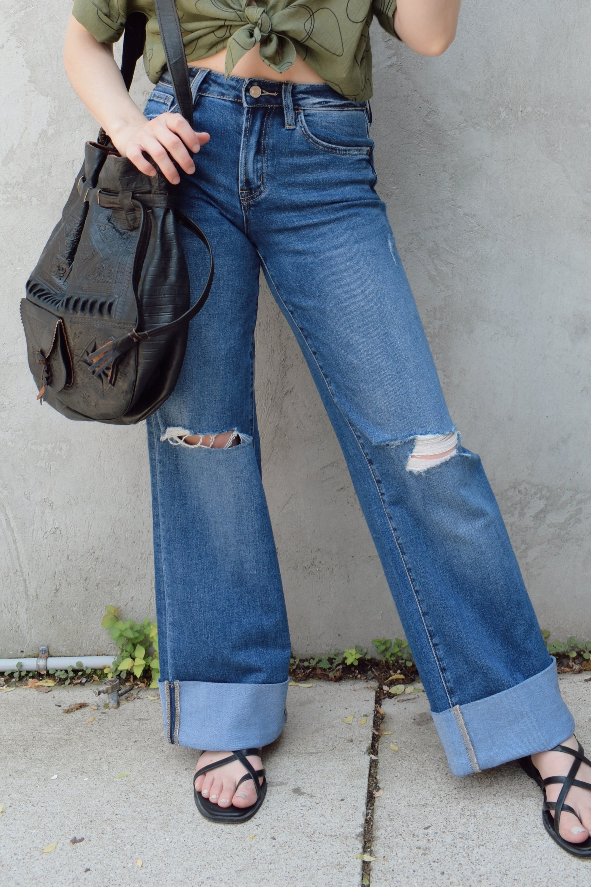wide leg wide cuff at hem stretch denim jeans with holes in both knees, full length, dark wash, zip and button enclosure