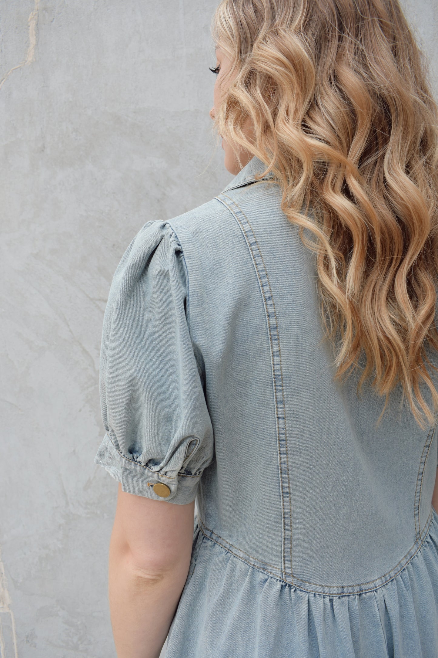 denim midi dress light wash with puff short sleeves with button cuffs button down front, v neck and collar, gathered at waist with a line skirt, has pockets