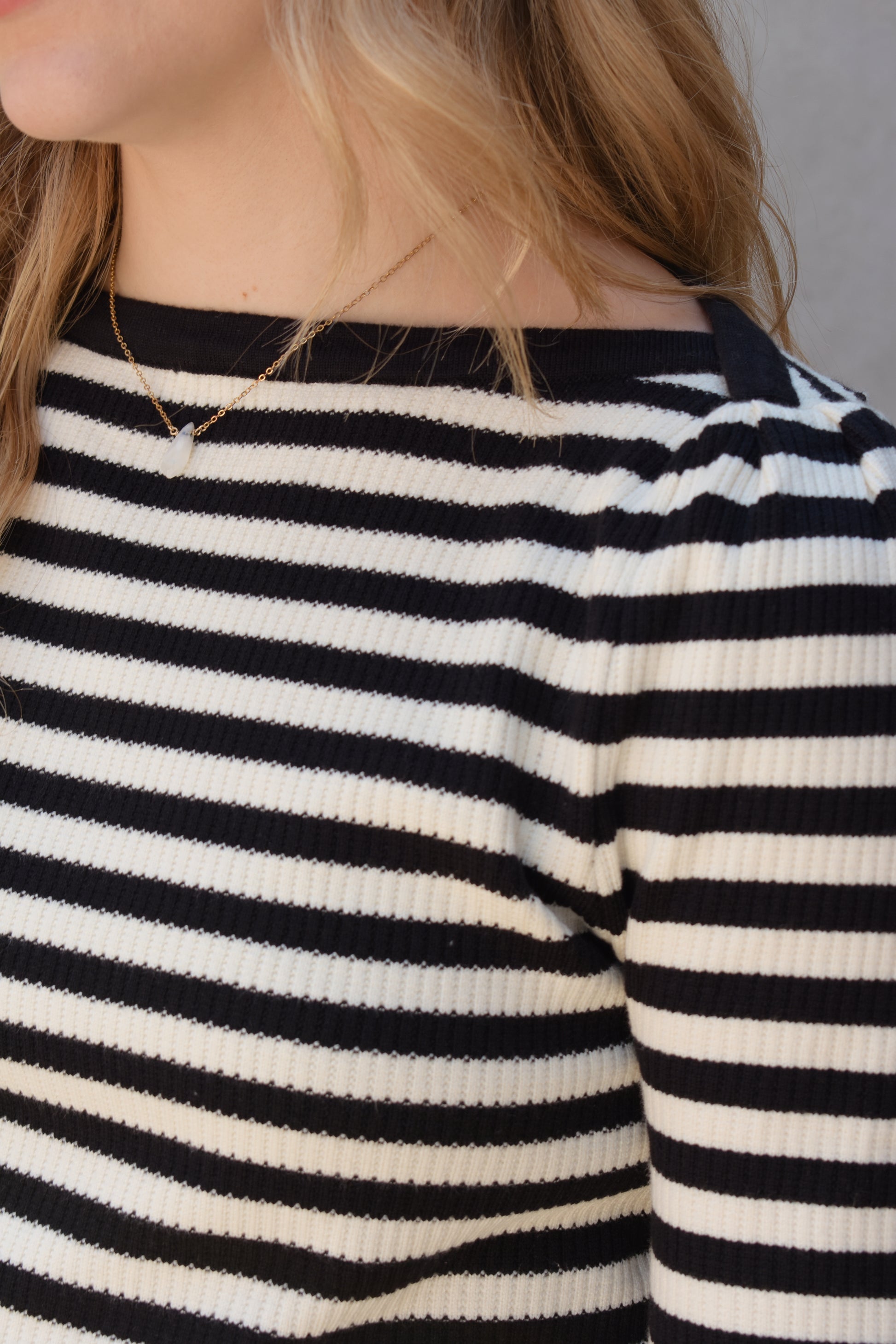 black and white horizontal striped long sleeve sweater with boat neckline and gathered puff shoulders (very slight), fitted, full length, solid black around neckline