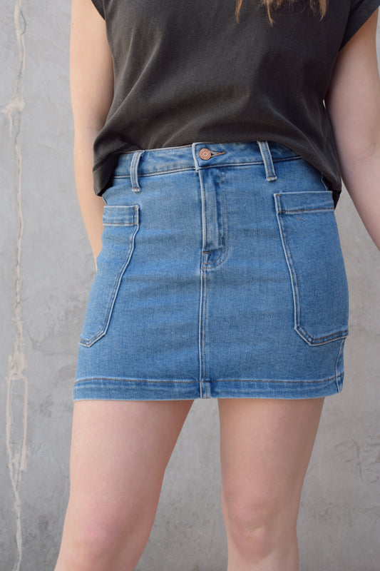 mini medium wash denim skirt stretch denim with big side patch pockets zip and button enclosure no distressing has beltloops