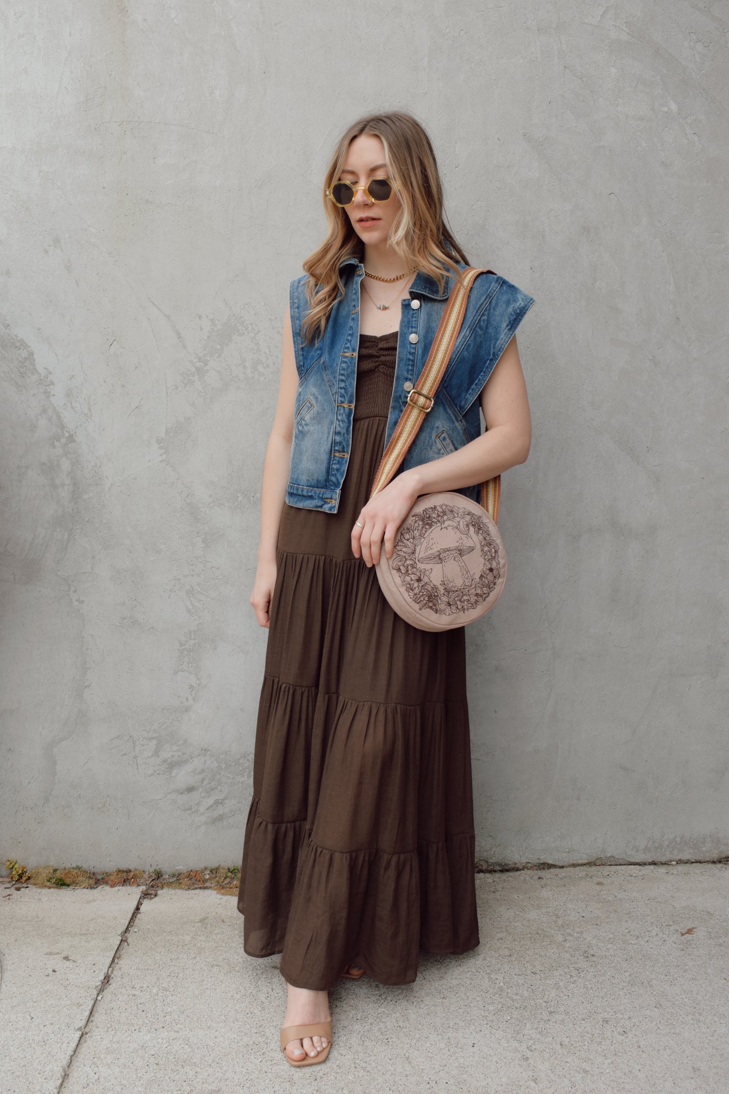 denim full length vest medium wash with some lighter wash marks no holes seam details along front side and back has slit pockets front button enclosure and structured shoulders