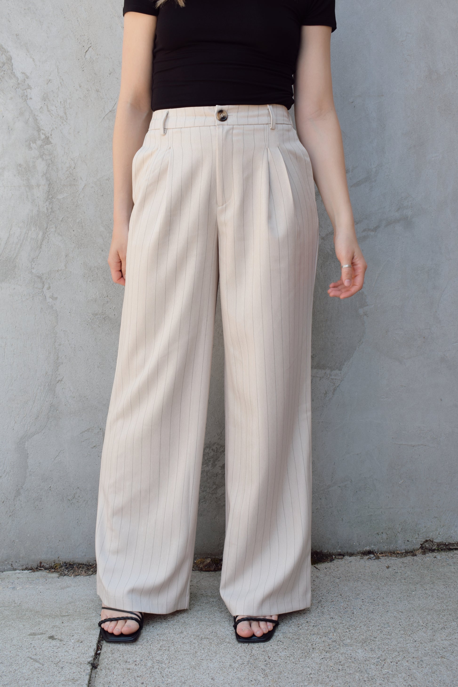 vertical pinstripe trousers with front pleats, pockets, zip and button enclosure, has beltloops, fake back pockets, elastic on back of waistband, full length