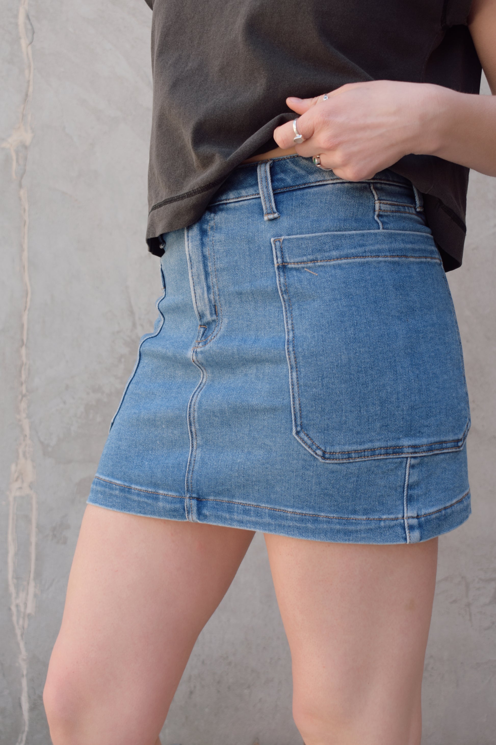 mini medium wash denim skirt stretch denim with big side patch pockets zip and button enclosure no distressing has beltloops