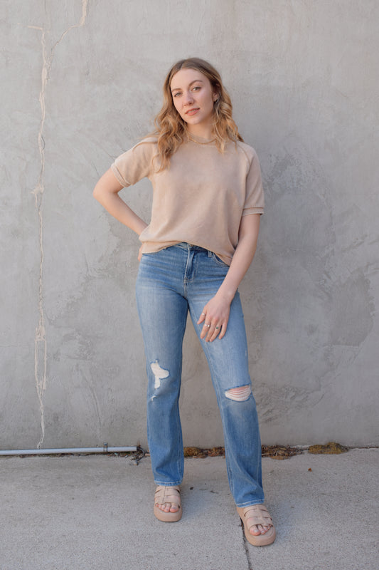 high rise straight jeans medium to light wash with distressing and holes at knees full length high waisted has beltloops stretch denim