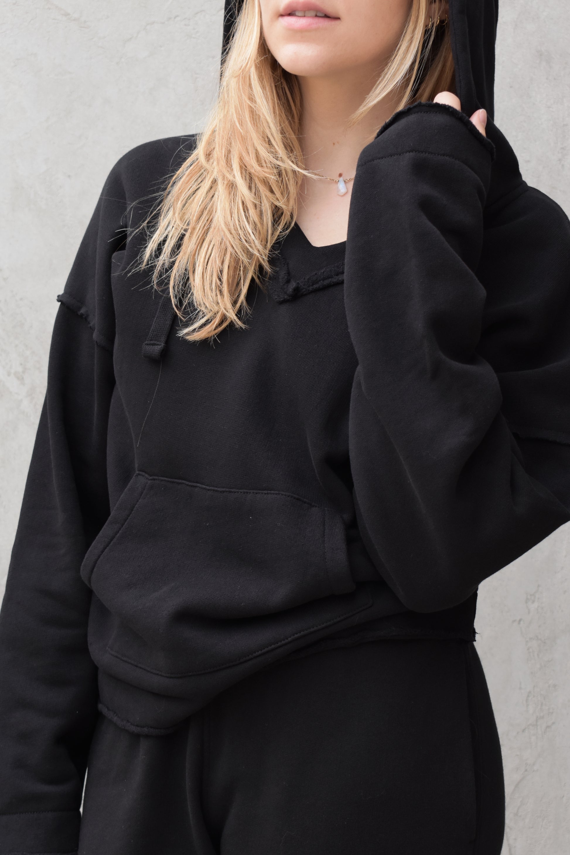 black v neck hoodie - double layered hood with drawstring, drop shoulder, kangaroo pocket, full length relaxed fit, raw edge hems