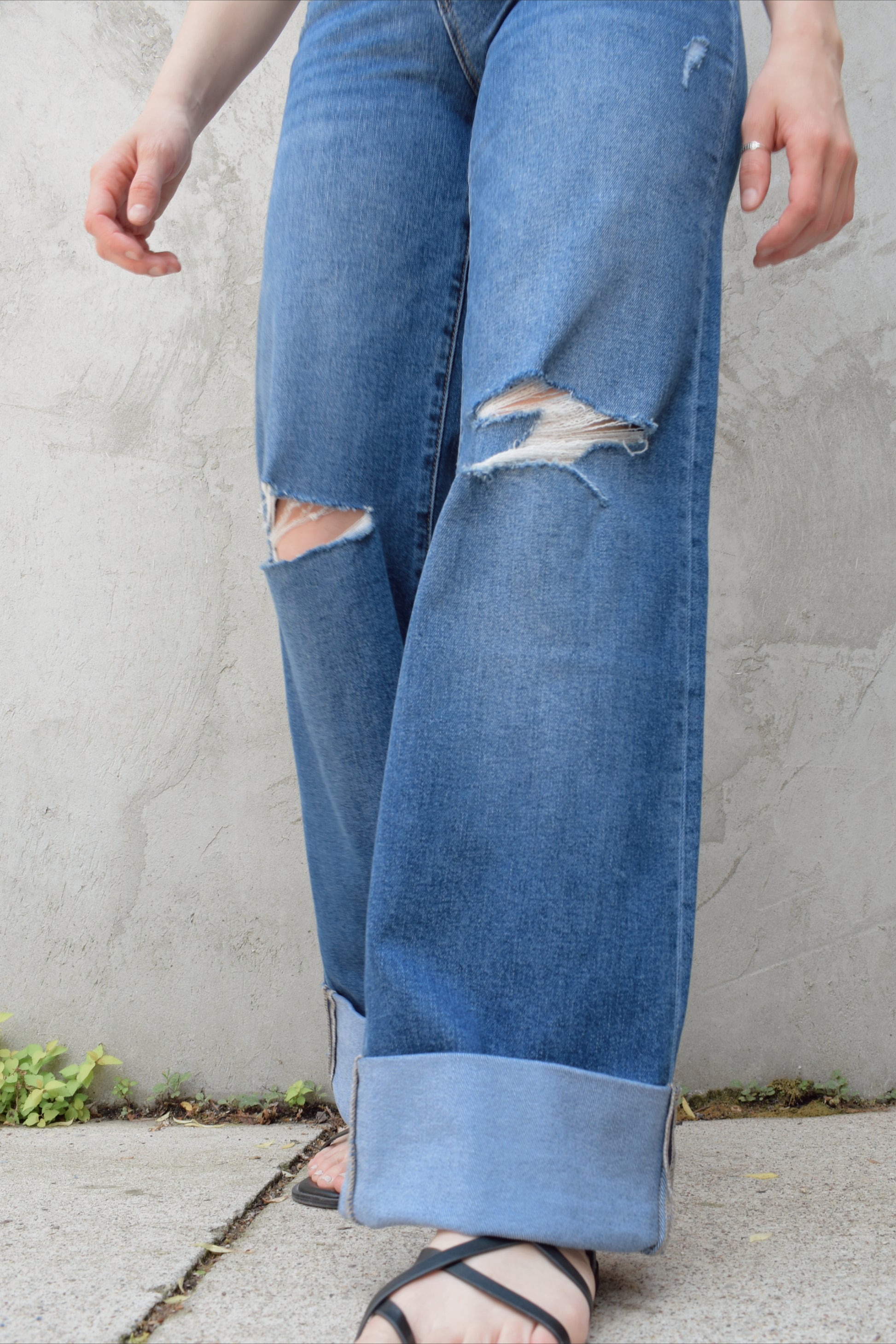 wide leg wide cuff at hem stretch denim jeans with holes in both knees, full length, dark wash, zip and button enclosure