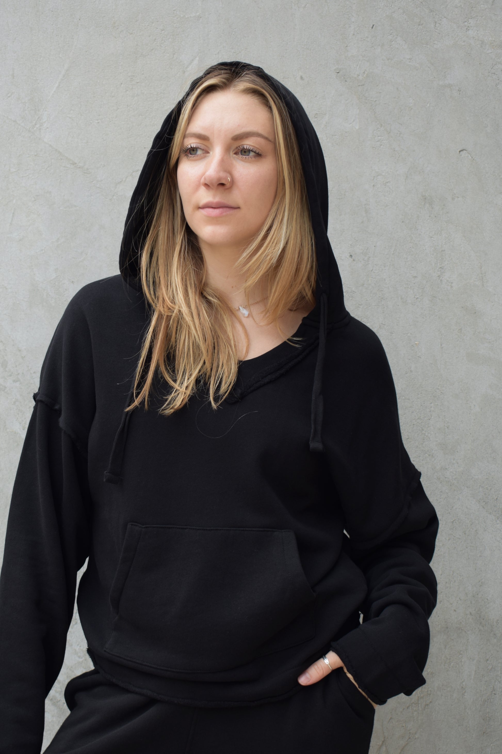 black v neck hoodie - double layered hood with drawstring, drop shoulder, kangaroo pocket, full length relaxed fit, raw edge hems