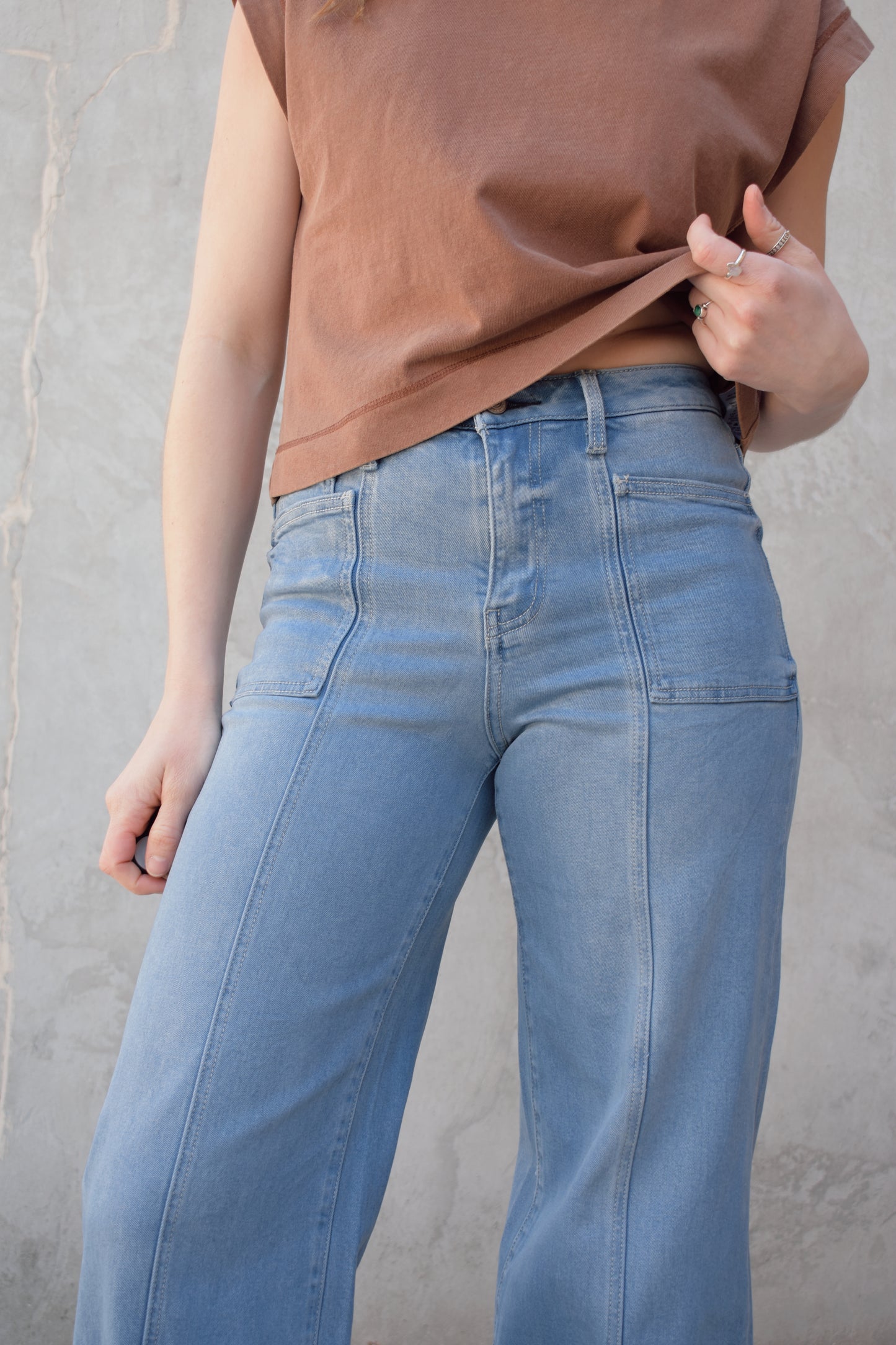 high waisted wide leg full length stretch denim retro jeans with front patch pockets front seam detail light wash no distressing or holes has beltloops zip and button enclosure has back pockets