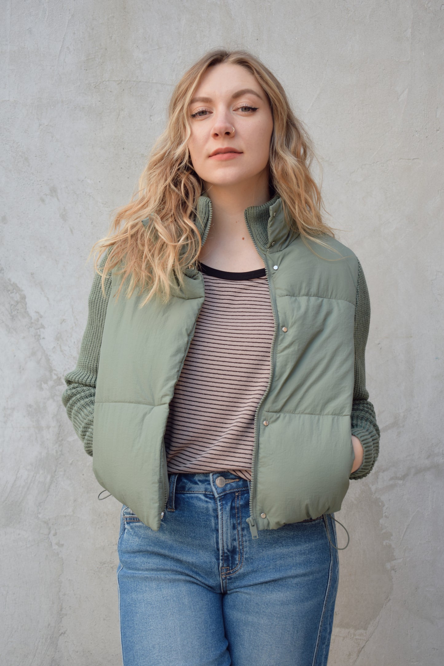blue green puffer jacket with ribbed knit sleeves, zip and snap front enclosure, has double collar with both materials, has pockets, sinch band at hem