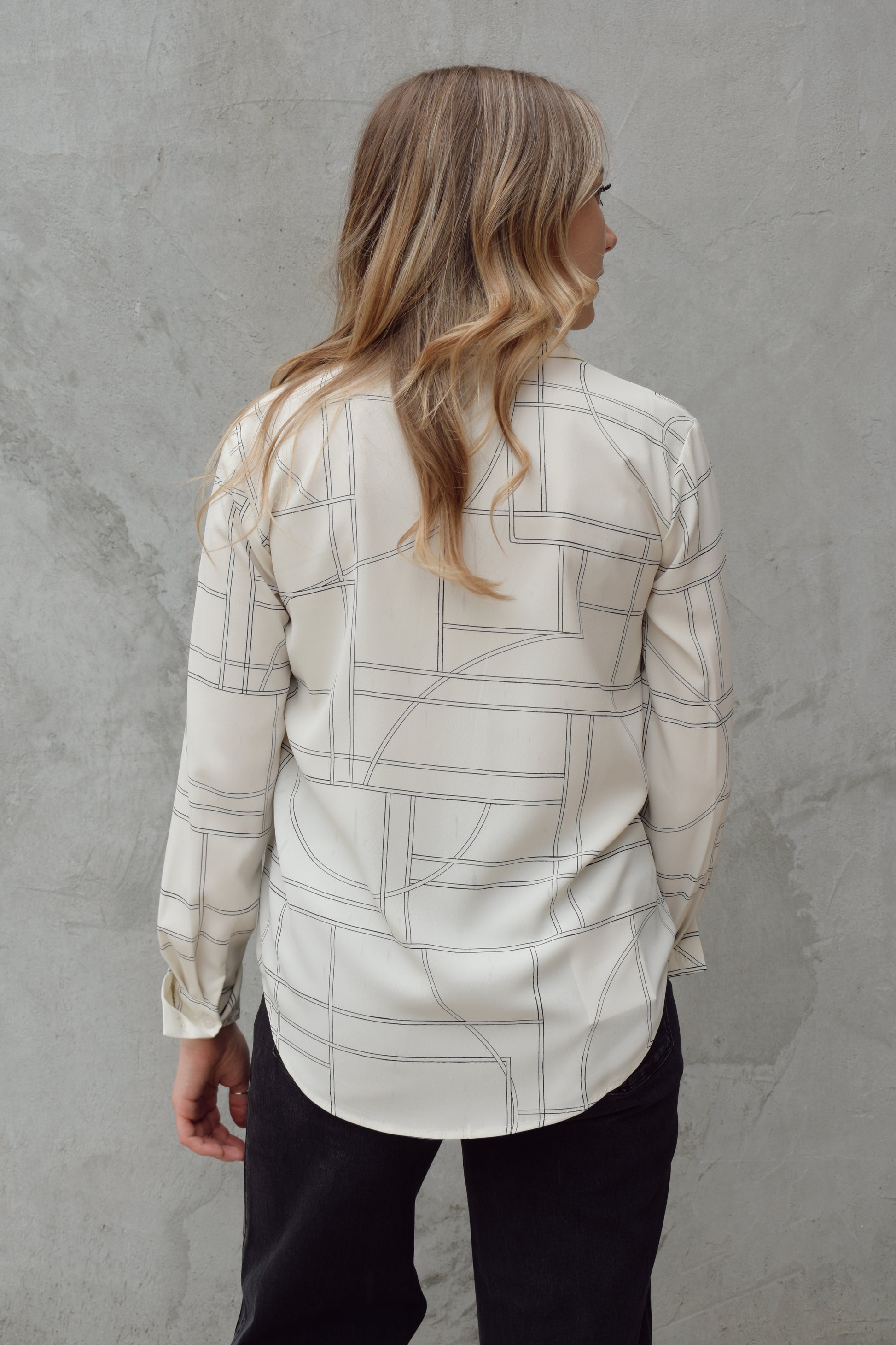 lightweight long sleeve off white button down blouse that has a chic geometric pattern, fitted cuffs, full length straight fit