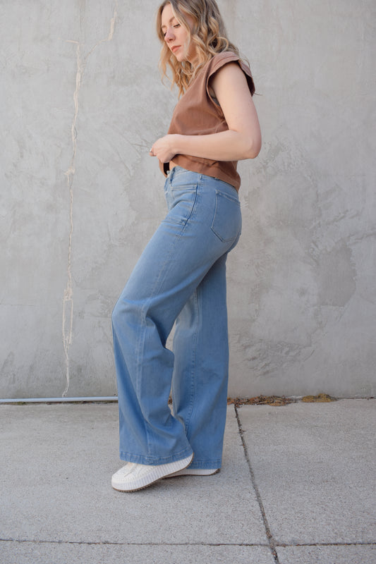 high waisted wide leg full length stretch denim retro jeans with front patch pockets front seam detail light wash no distressing or holes has beltloops zip and button enclosure has back pockets