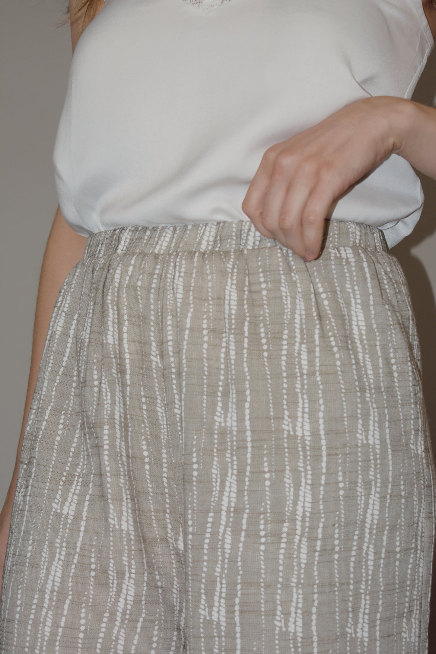 flowy cream and white printed pants slightly cropped, elastic waistband, has pockets, lightweight