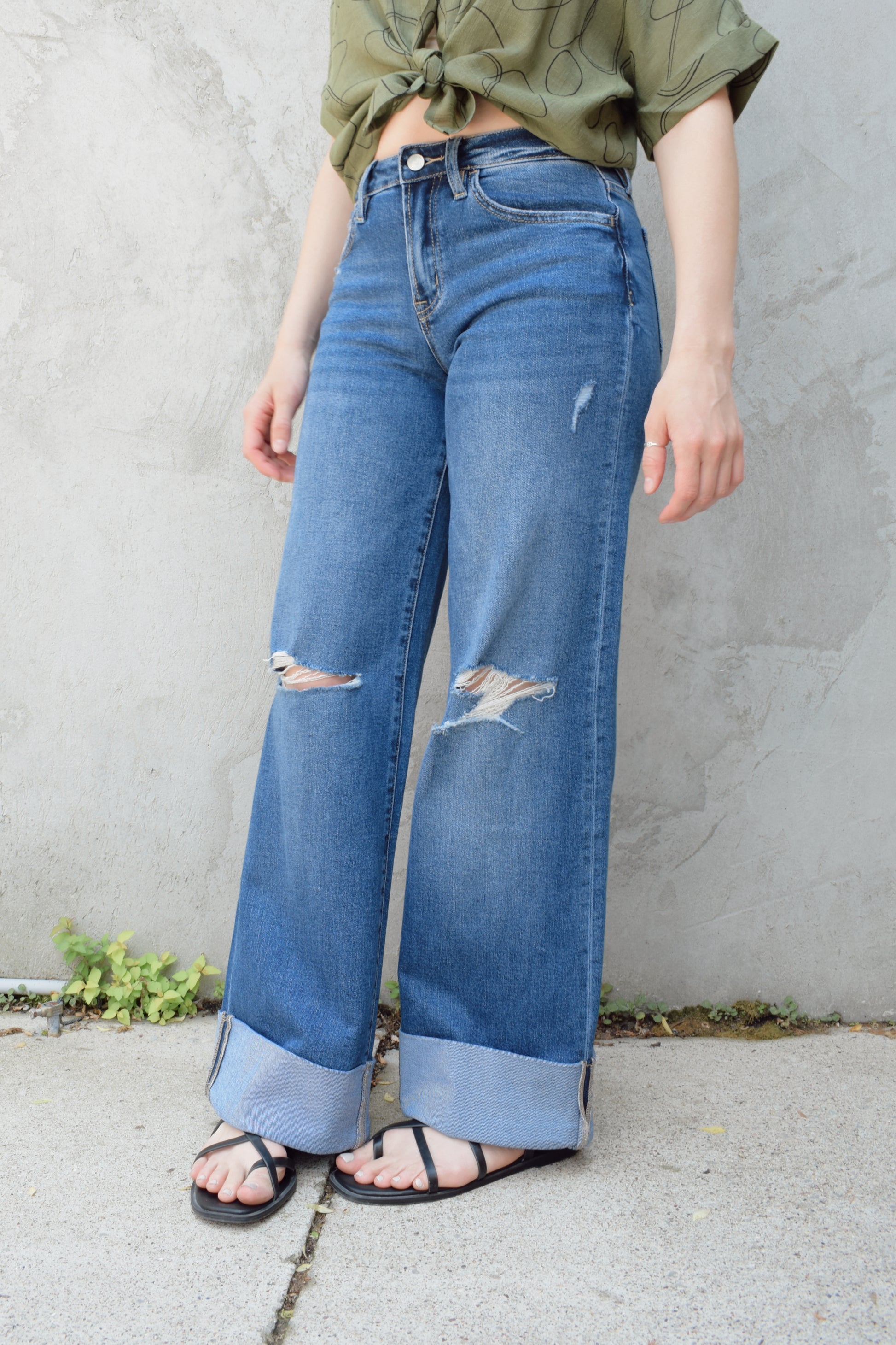 wide leg wide cuff at hem stretch denim jeans with holes in both knees, full length, dark wash, zip and button enclosure