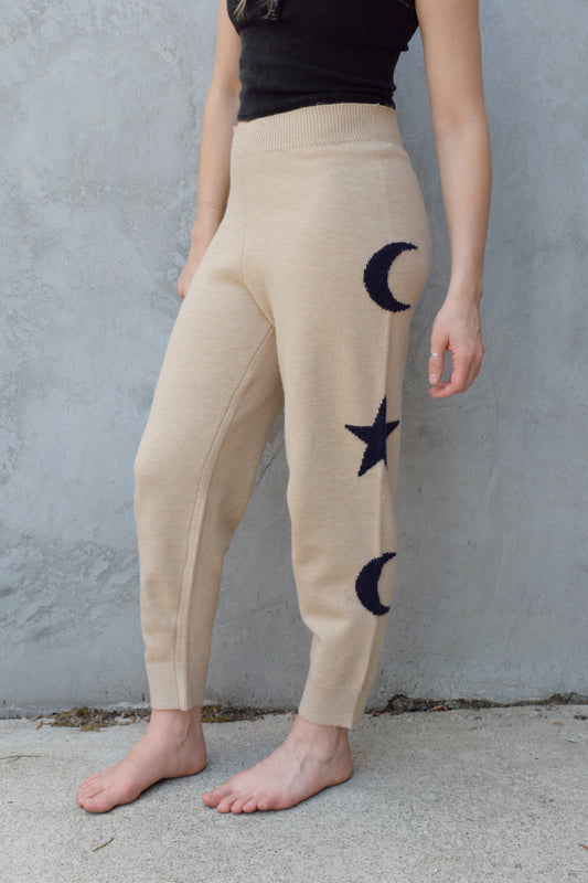 cream knit joggers with slightly elastic wide waistband, high waisted, moon and star design on sides of leg, relaxed fit, no pockets