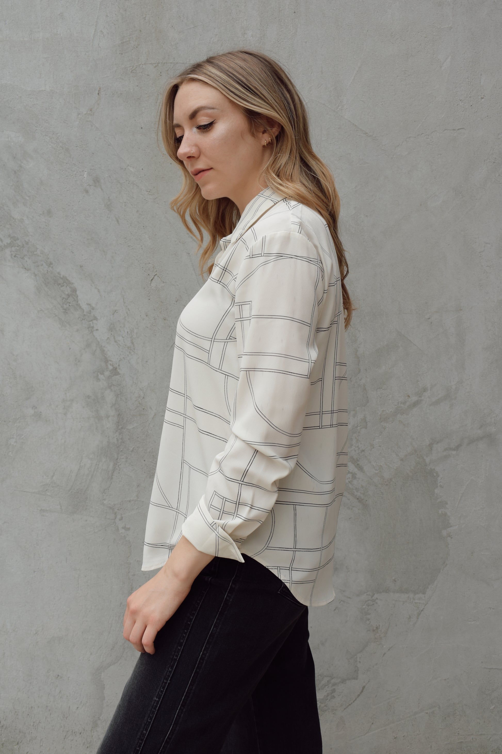 lightweight long sleeve off white button down blouse that has a chic geometric pattern, fitted cuffs, full length straight fit