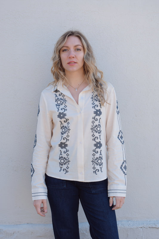 ivory button down full length with denim blue embroidery details along front, down sleeves, collar and cuffs. button cuffs, straight relaxed fit