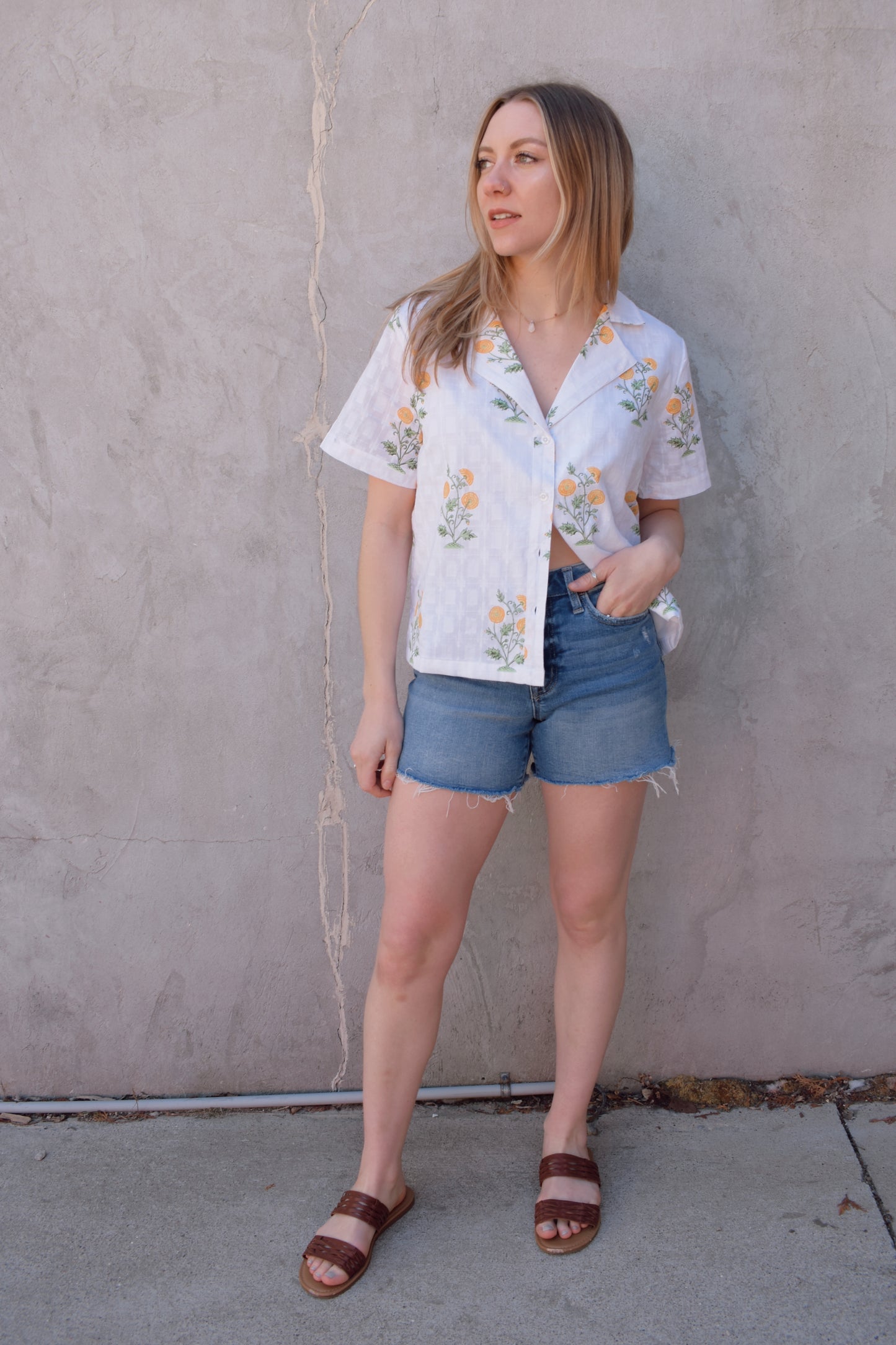 high rise stretch denim shorts with raw hem no holes front and back pockets zip and button enclosure has beltloops medium wash