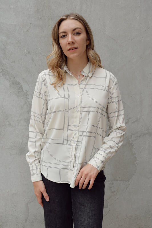 lightweight long sleeve off white button down blouse that has a chic geometric pattern, fitted cuffs, full length straight fit, scoop hem