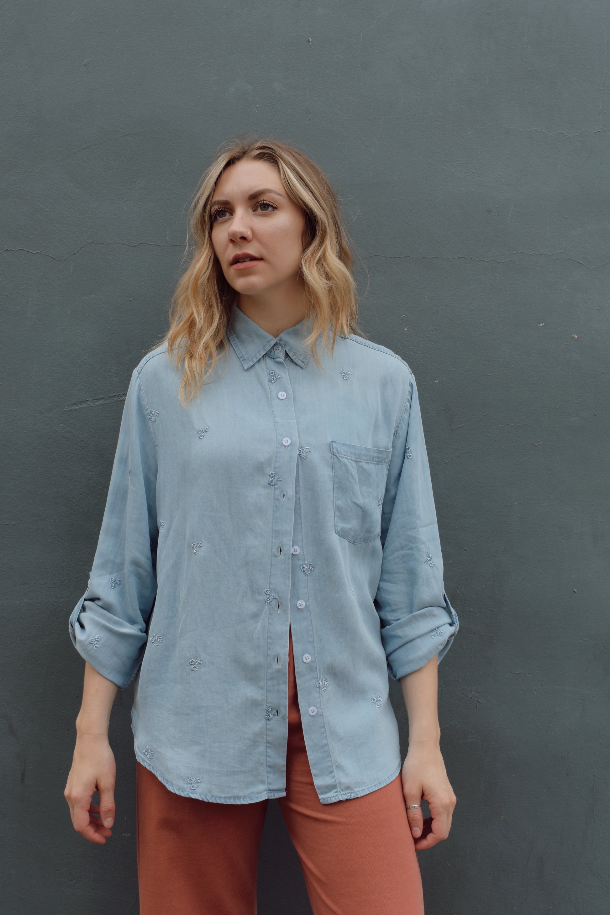 tencel denim chambray button down shirt, oversized relaxed fit, delicate floral embroidery accents same color as button down, one breast patch pocket, sleeves have button for roll up option