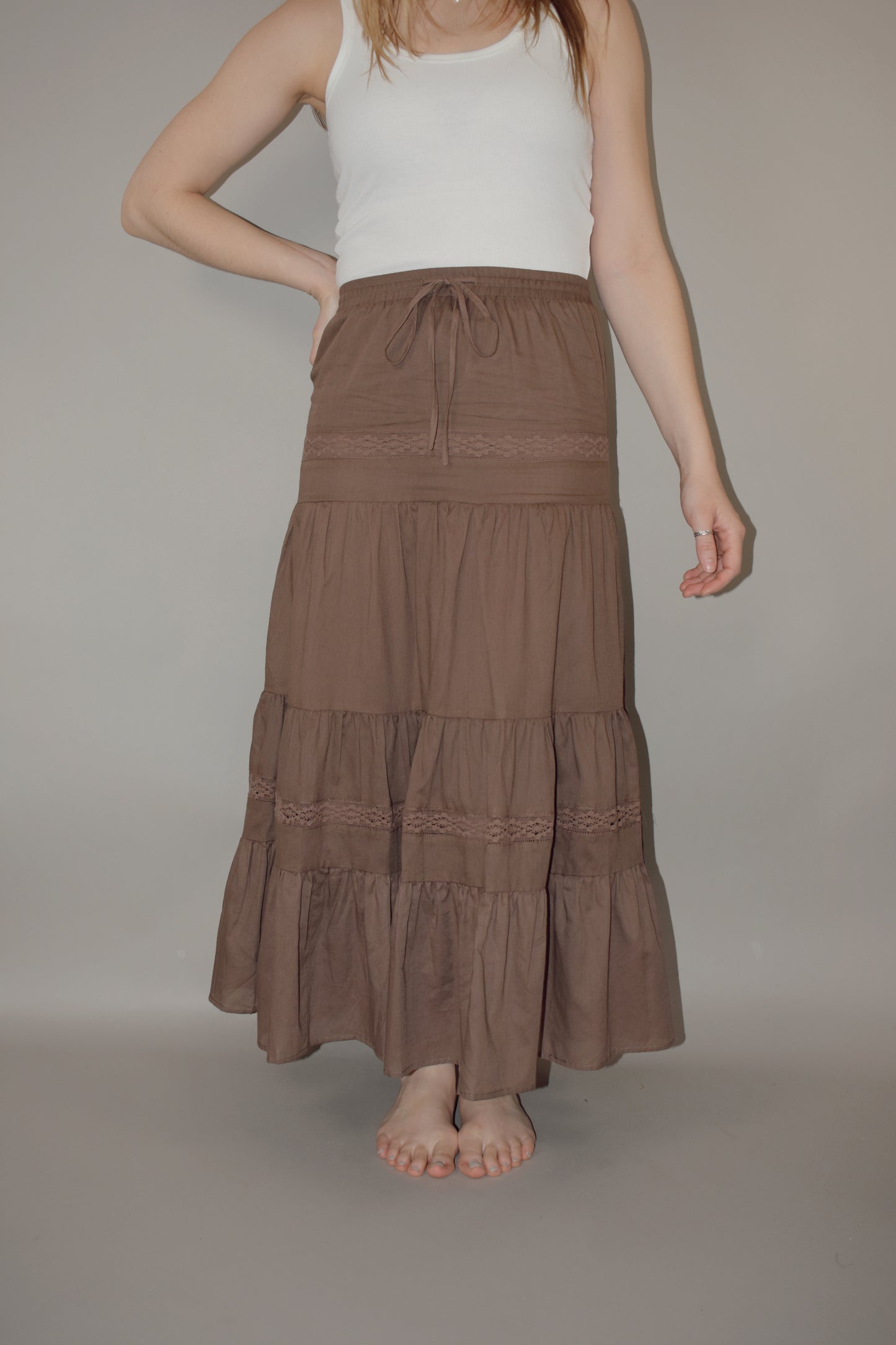 tiered maxi skirt with lace detailing and a elastic waistband with drawstring, has a liner