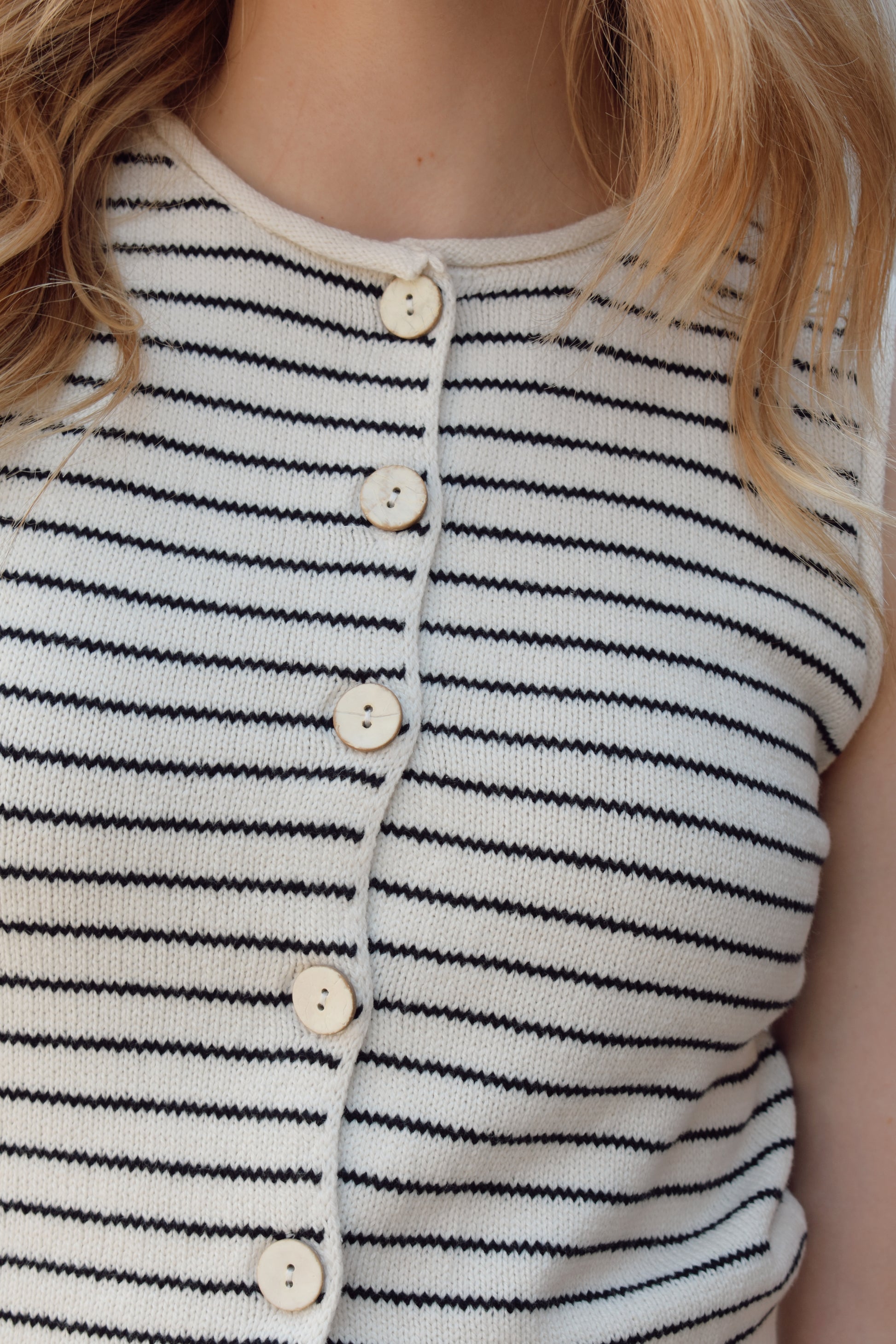 cropped striped sweater vest natural colored buttons down the front, crew neck, pin horizontal black stripes, solid ribbed hem