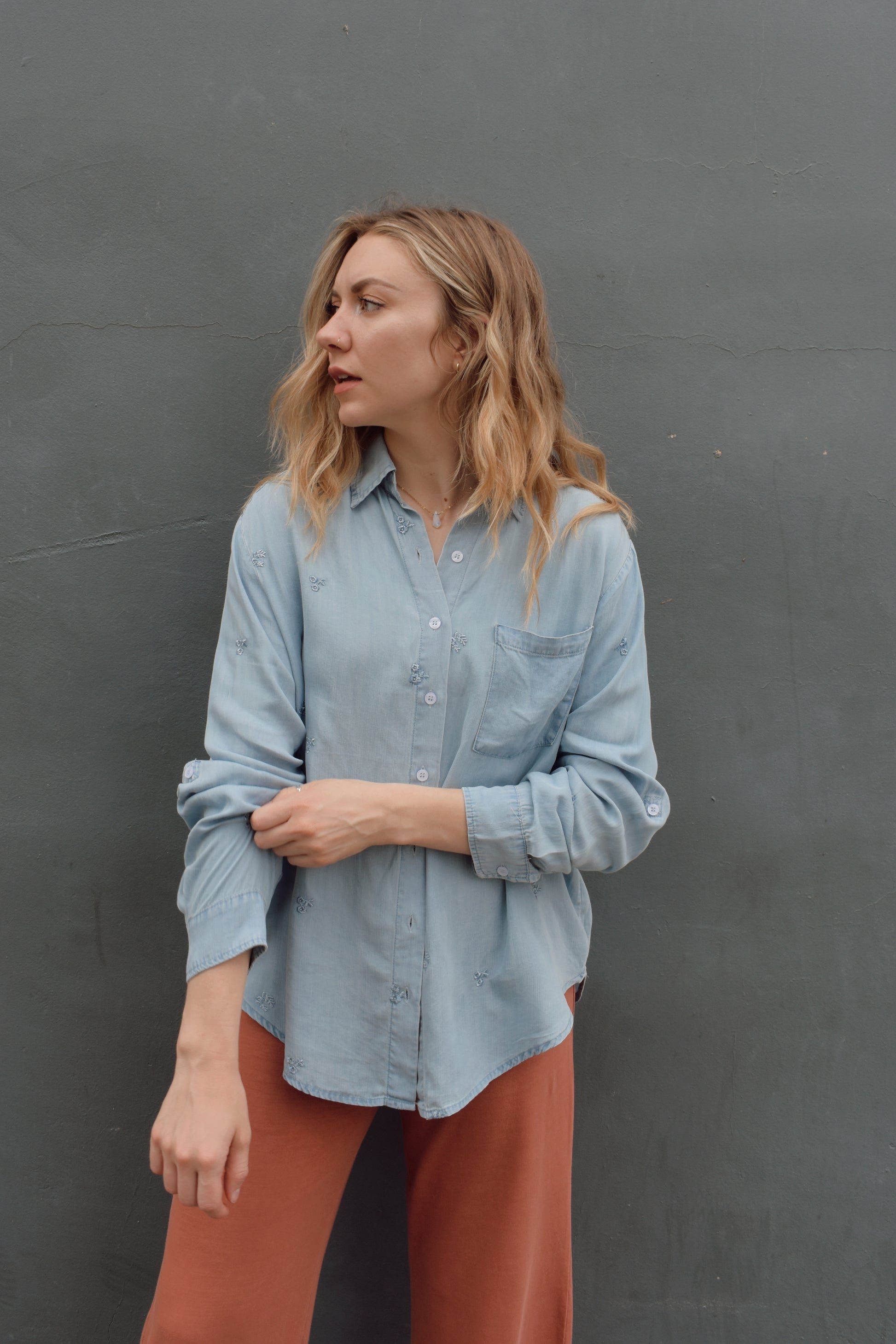 tencel denim chambray button down shirt, oversized relaxed fit, delicate floral embroidery accents same color as button down, one breast patch pocket, sleeves have button for roll up option