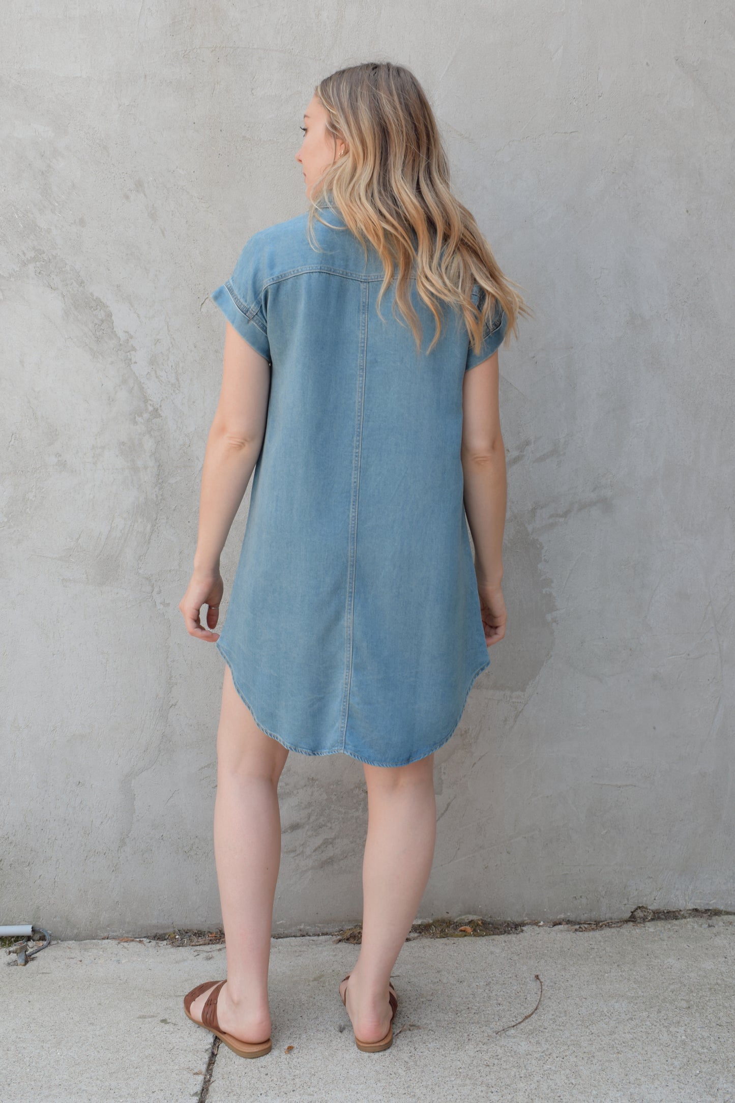 short sleeve button down denim colored medium wash mini dress straight fit has front pockets and patch breast pockets has collar and buttons down the whole front