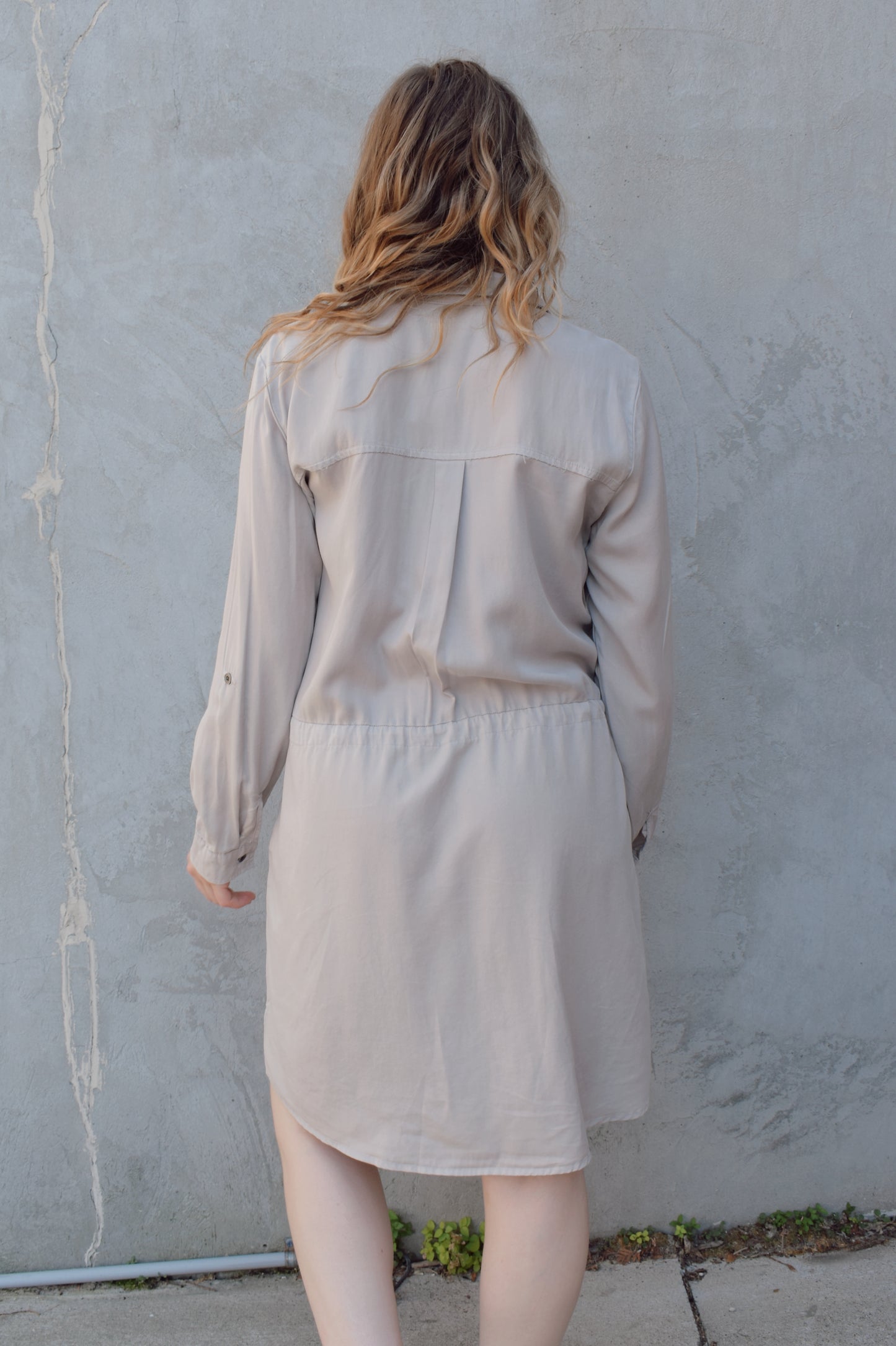 tencel utility long sleeve mini dress with cuff and button sleeves, button down front enclosure, drawstring at waist, breast utility patch pockets with flap and button enclosure, has side pockets, scoop and side slit hem, loose fit