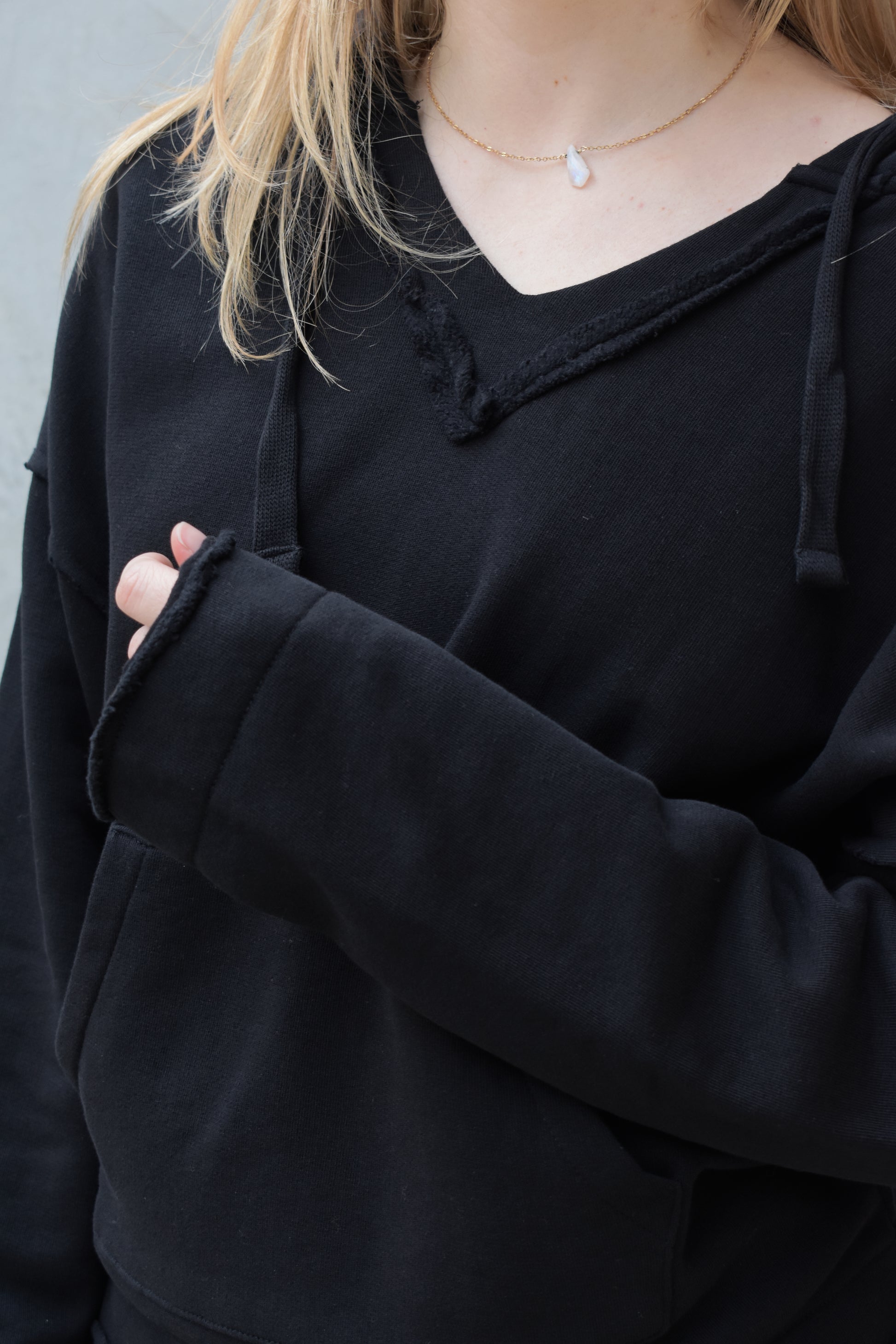 black v neck hoodie - double layered hood with drawstring, drop shoulder, kangaroo pocket, full length relaxed fit, raw edge hems