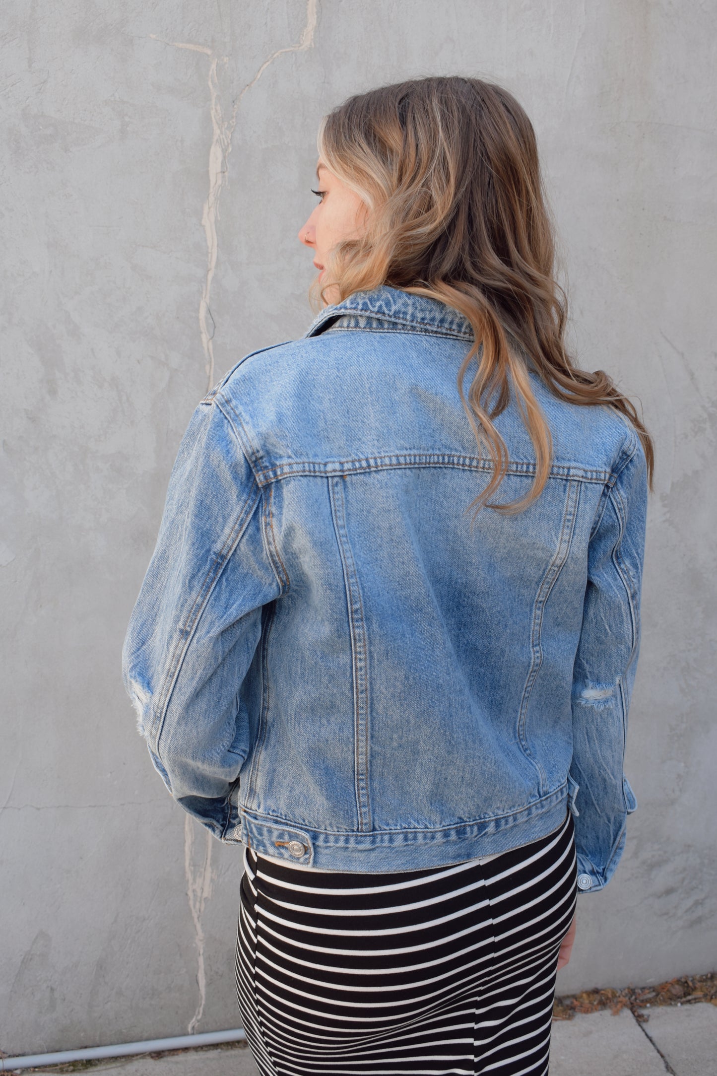 medium wash distressed jean jacket staple for wardrobe relaxed fit full length