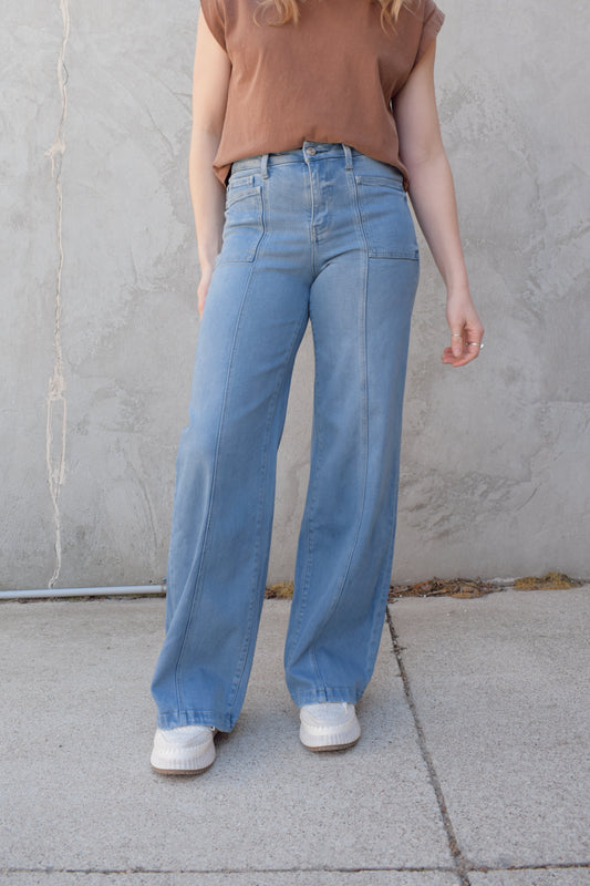 high waisted wide leg full length stretch denim retro jeans with front patch pockets front seam detail light wash no distressing or holes has beltloops zip and button enclosure has back pockets